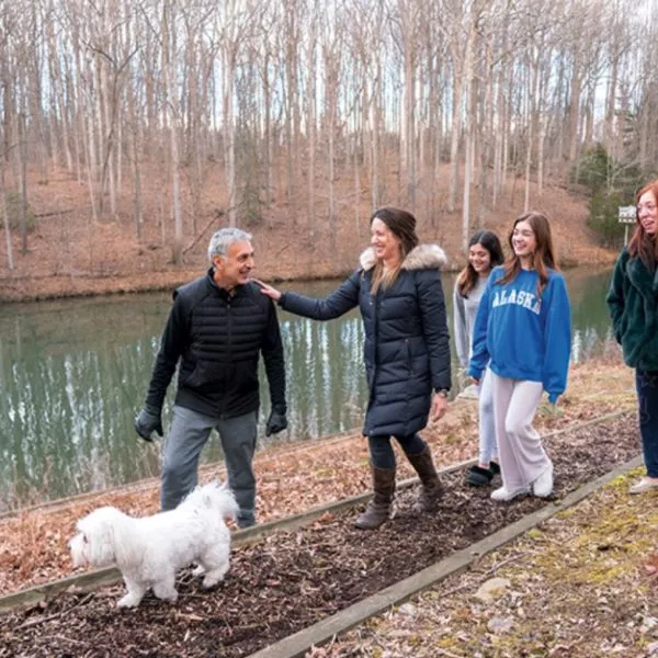 Reza with his family walking their dog