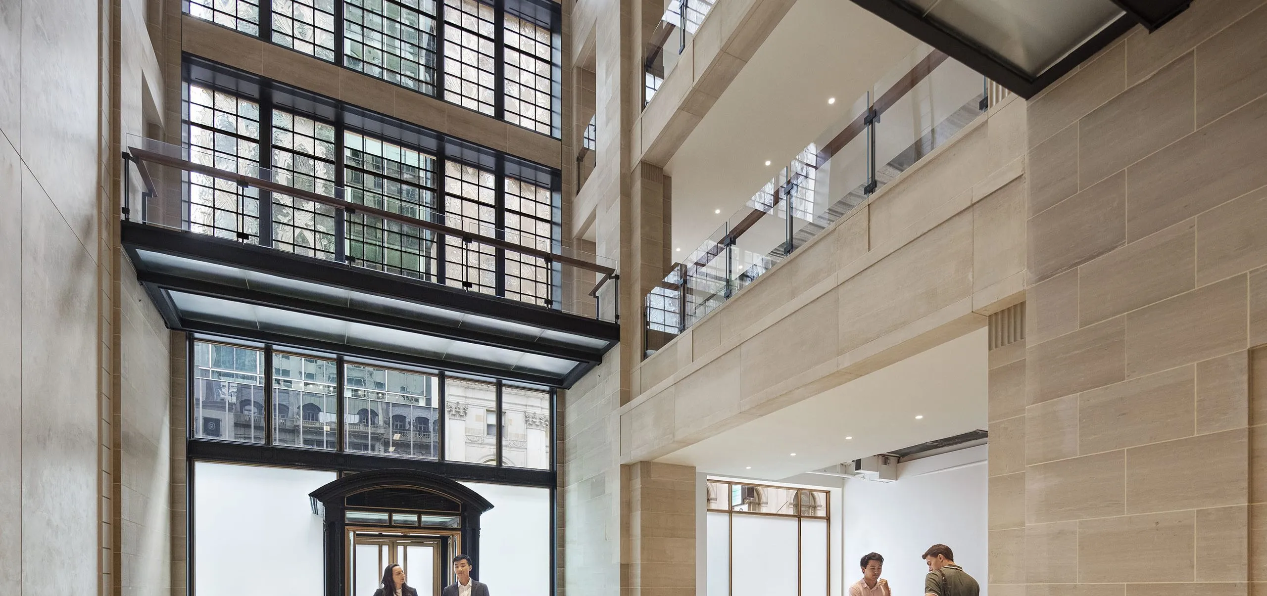 People in entryway with high ceilings in 712 Fifth Avenue