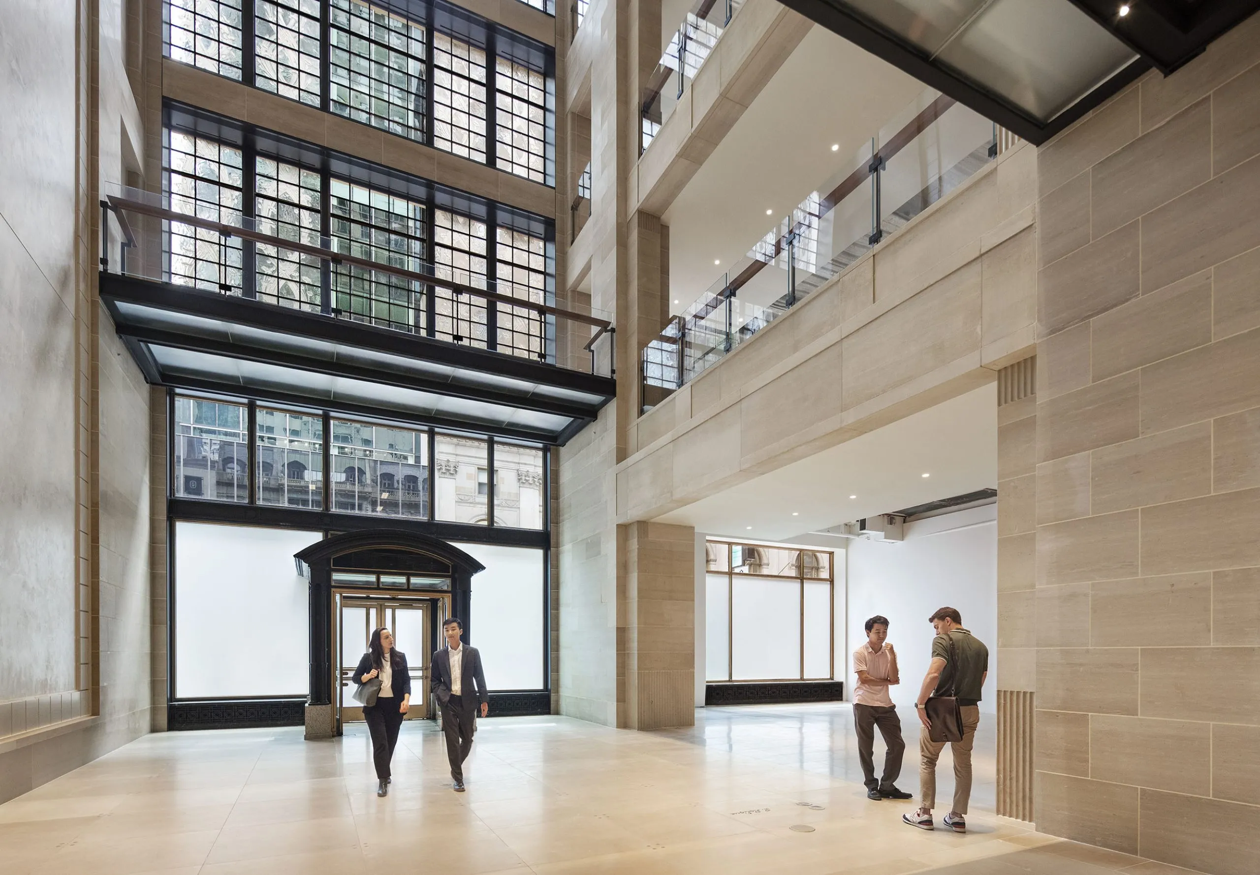 People in entryway with high ceilings in 712 Fifth Avenue