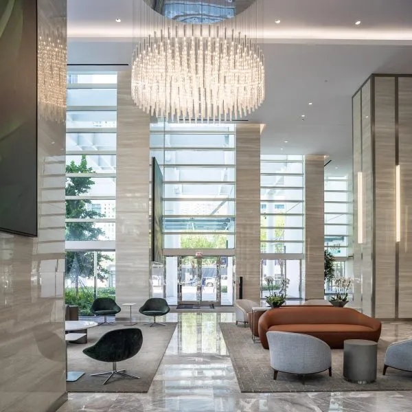 Modern upscale lobby with seating and large chandelier at 801 Brickell