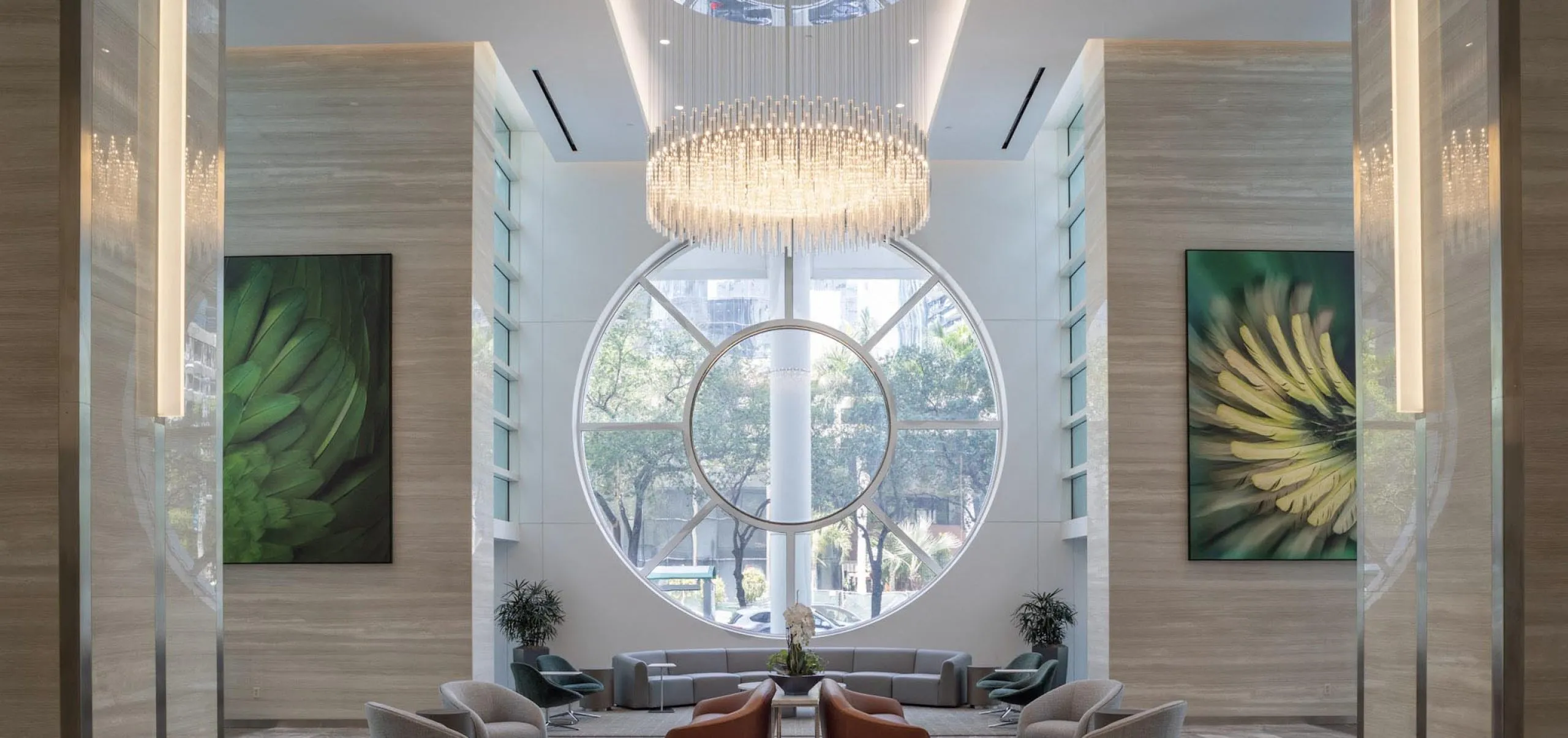 Modern upscale lobby with seating and large chandelier at 801 Brickell