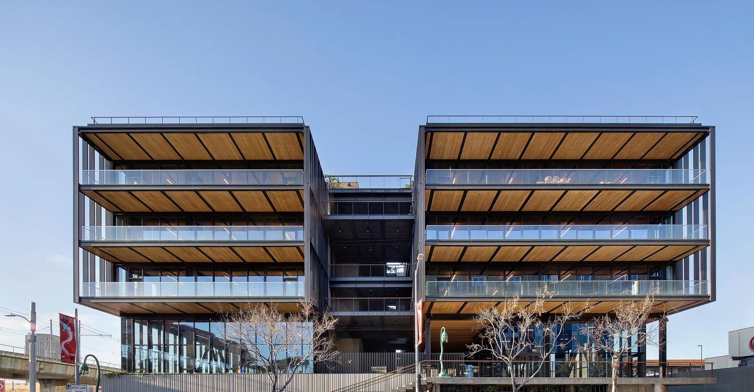 Exterior view of multistory balconies on large modern timber office building at 843 N Spring Street