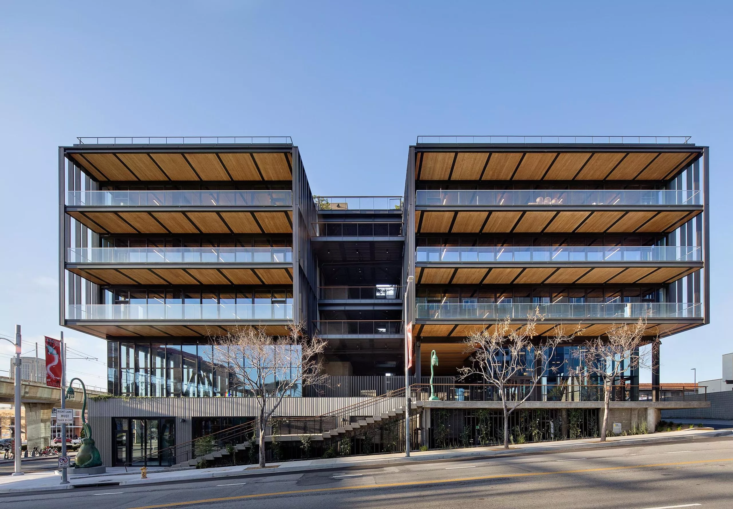 Exterior view of multistory balconies on large modern timber office building at 843 N Spring Street