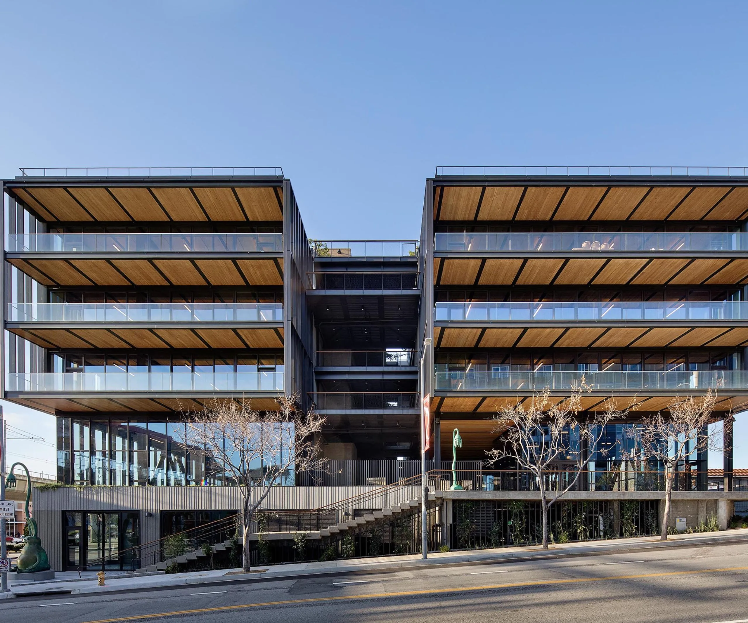 Exterior view of multistory balconies on large modern timber office building at 843 N Spring Street