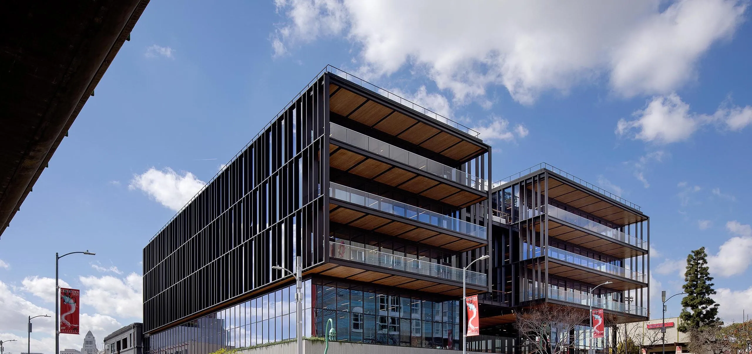 Exterior view of multistory balconies on large modern timber office building at 843 N Spring Street