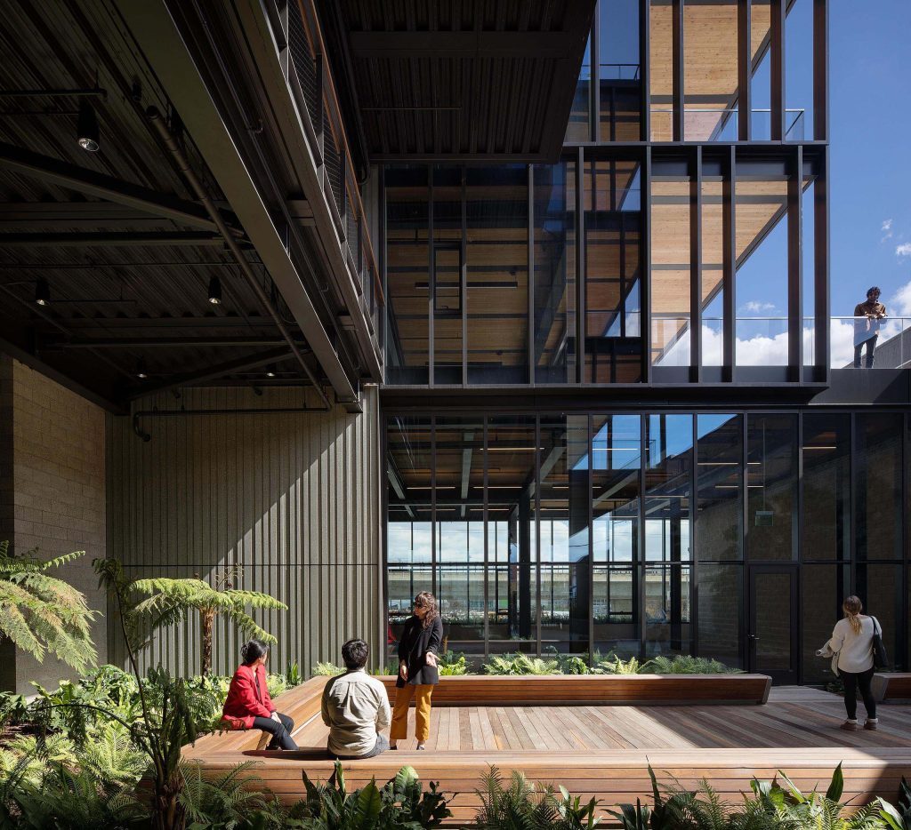 People talking in exterior wooden deck with garden at office building 843 N Spring Street