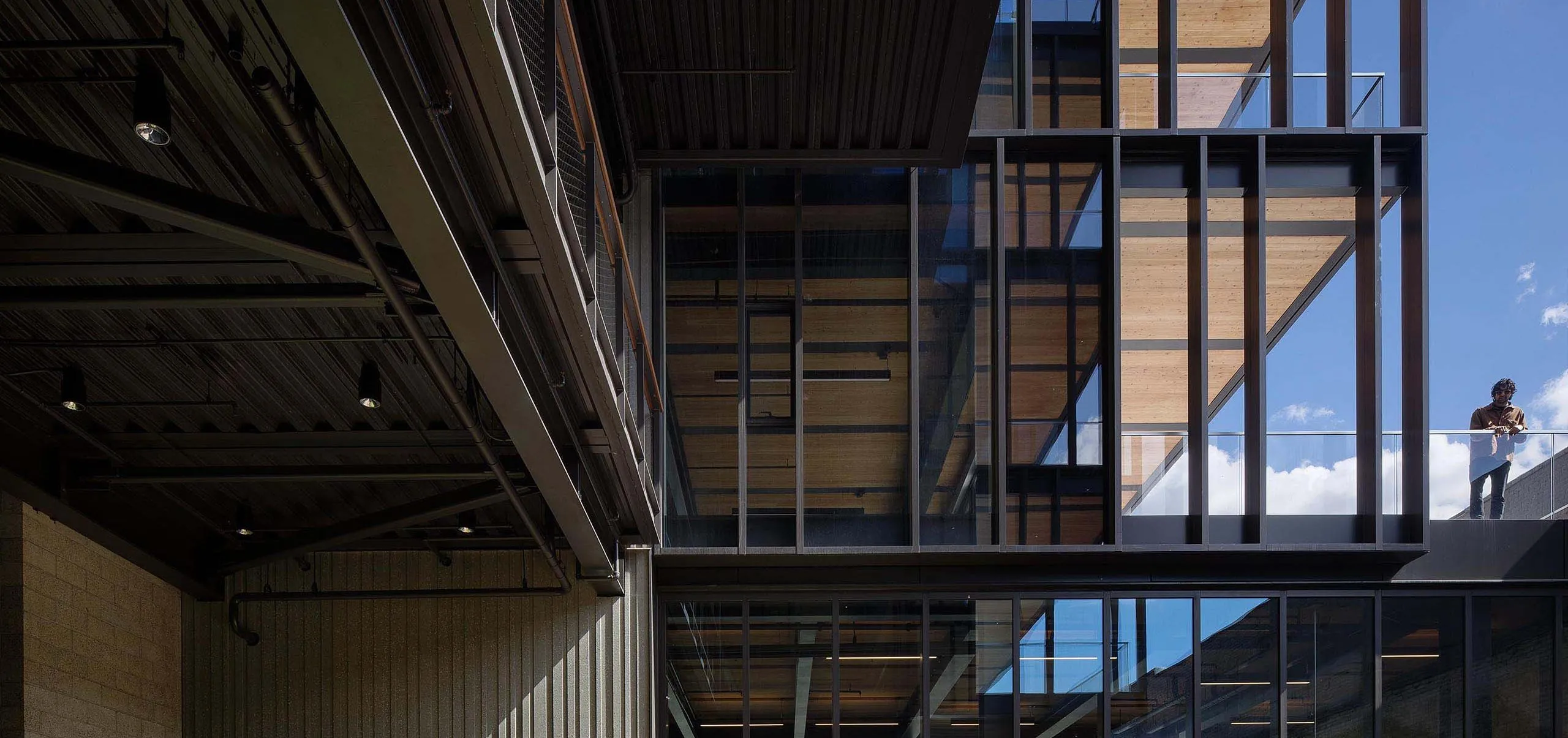 People talking in exterior wooden deck with garden at office building 843 N Spring Street