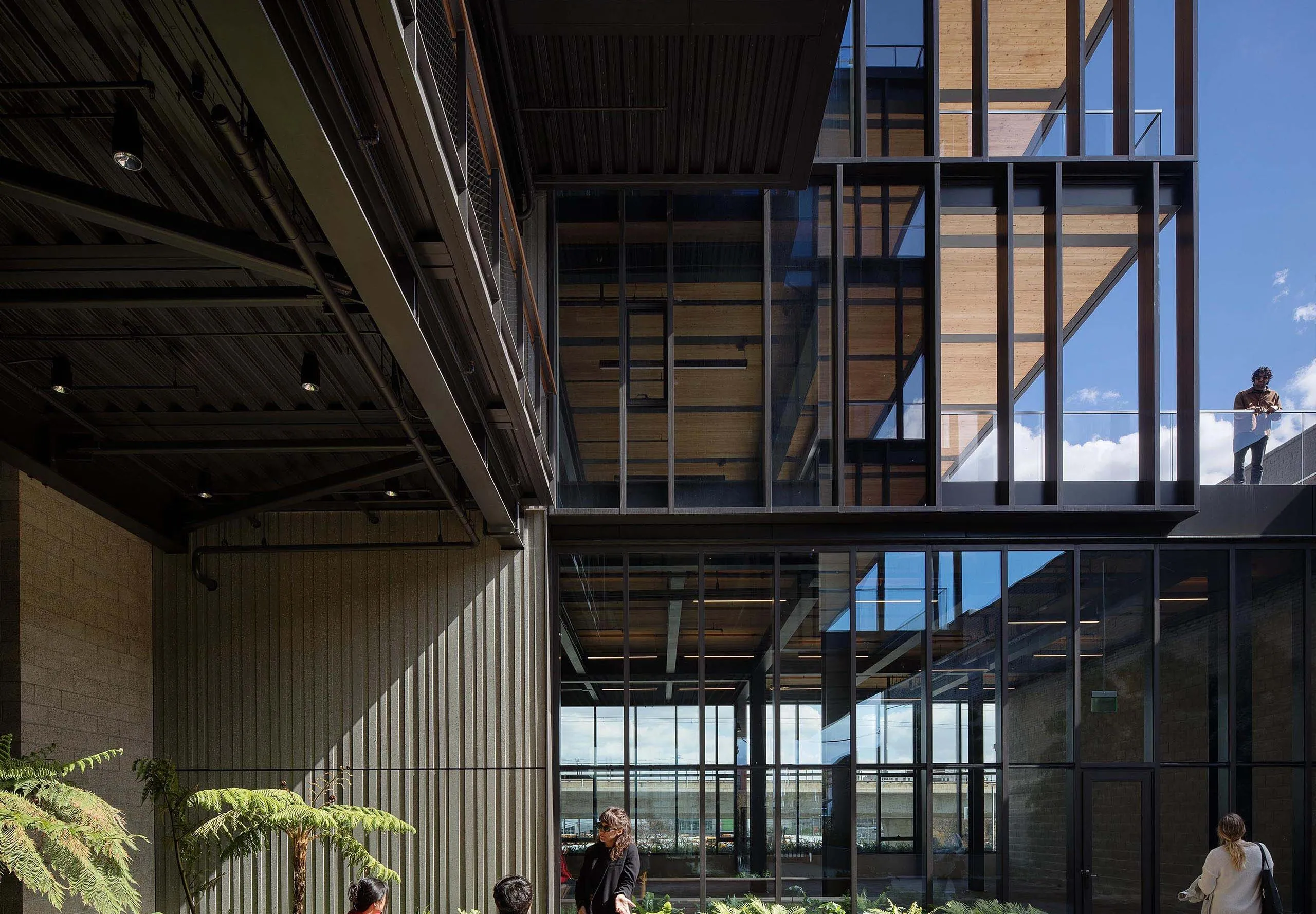 People talking in exterior wooden deck with garden at office building 843 N Spring Street