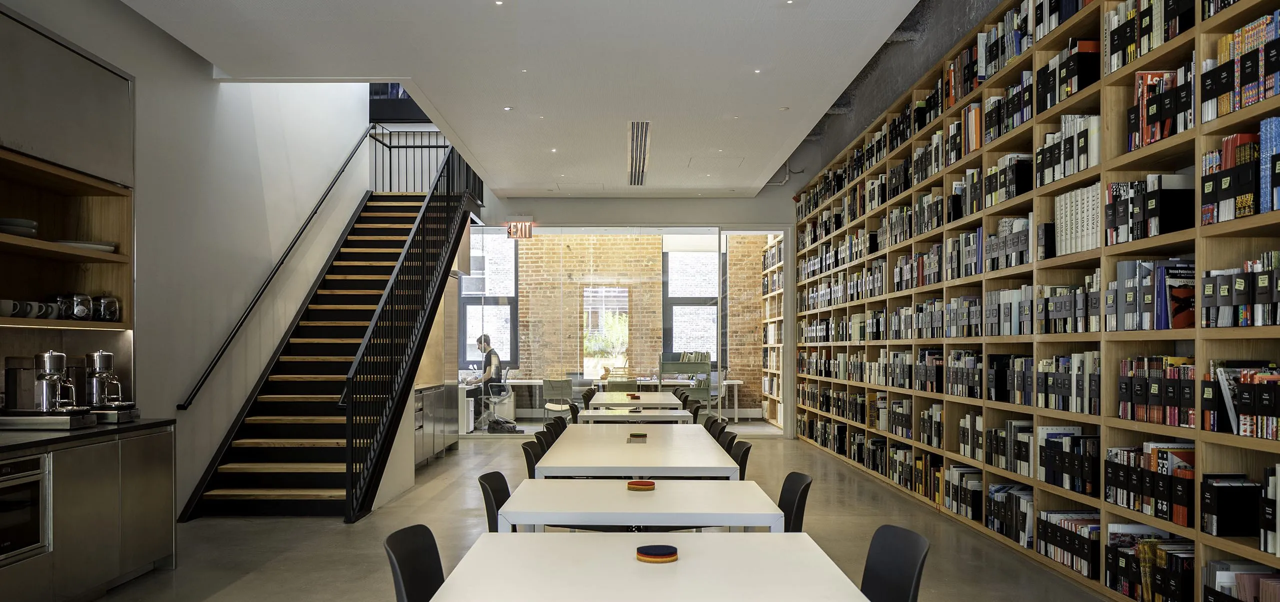 Kitchen and dining area with large bookshelves on wall