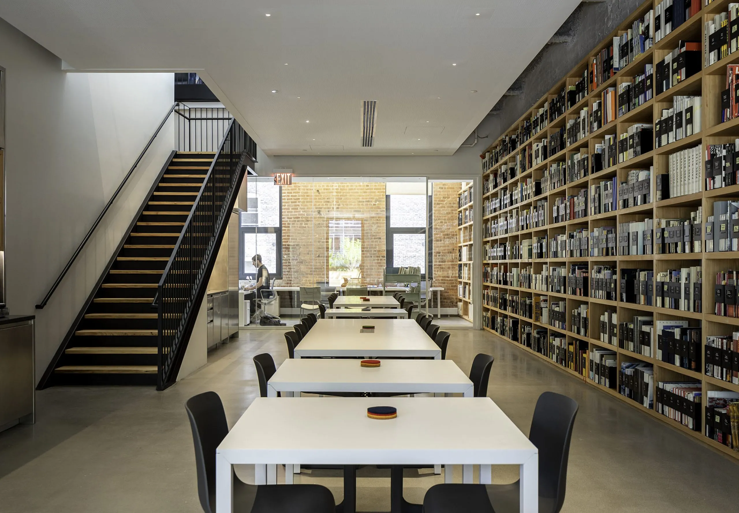 Kitchen and dining area with large bookshelves on wall