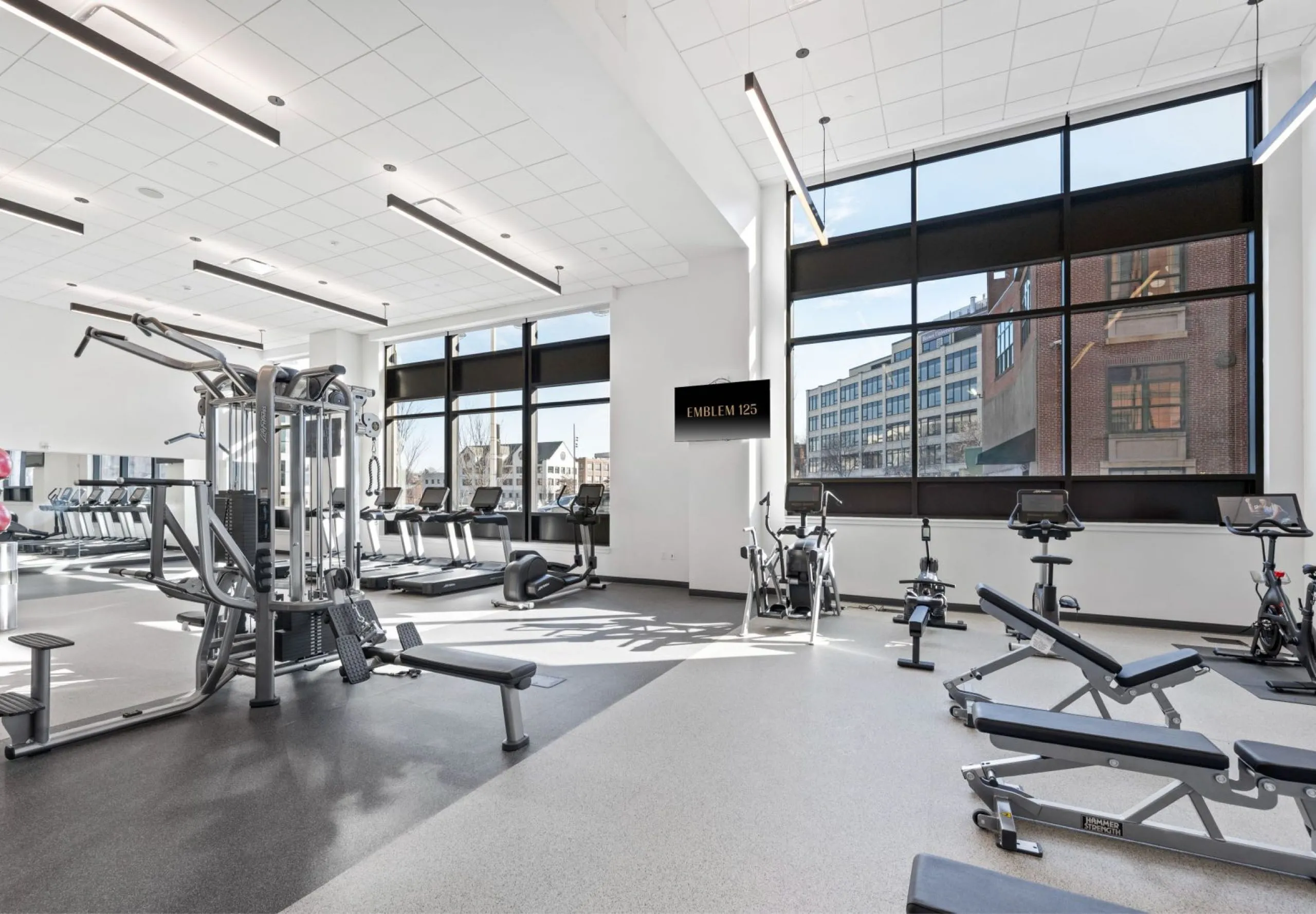 Communal gym with exercise equipment in Emblem 125