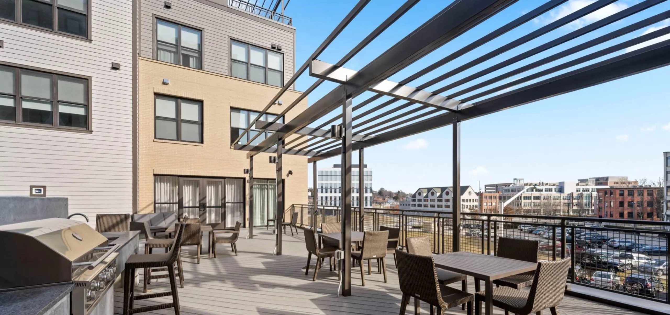 Grill and outdoor seating area in courtyard of Emblem 125 apartment complex