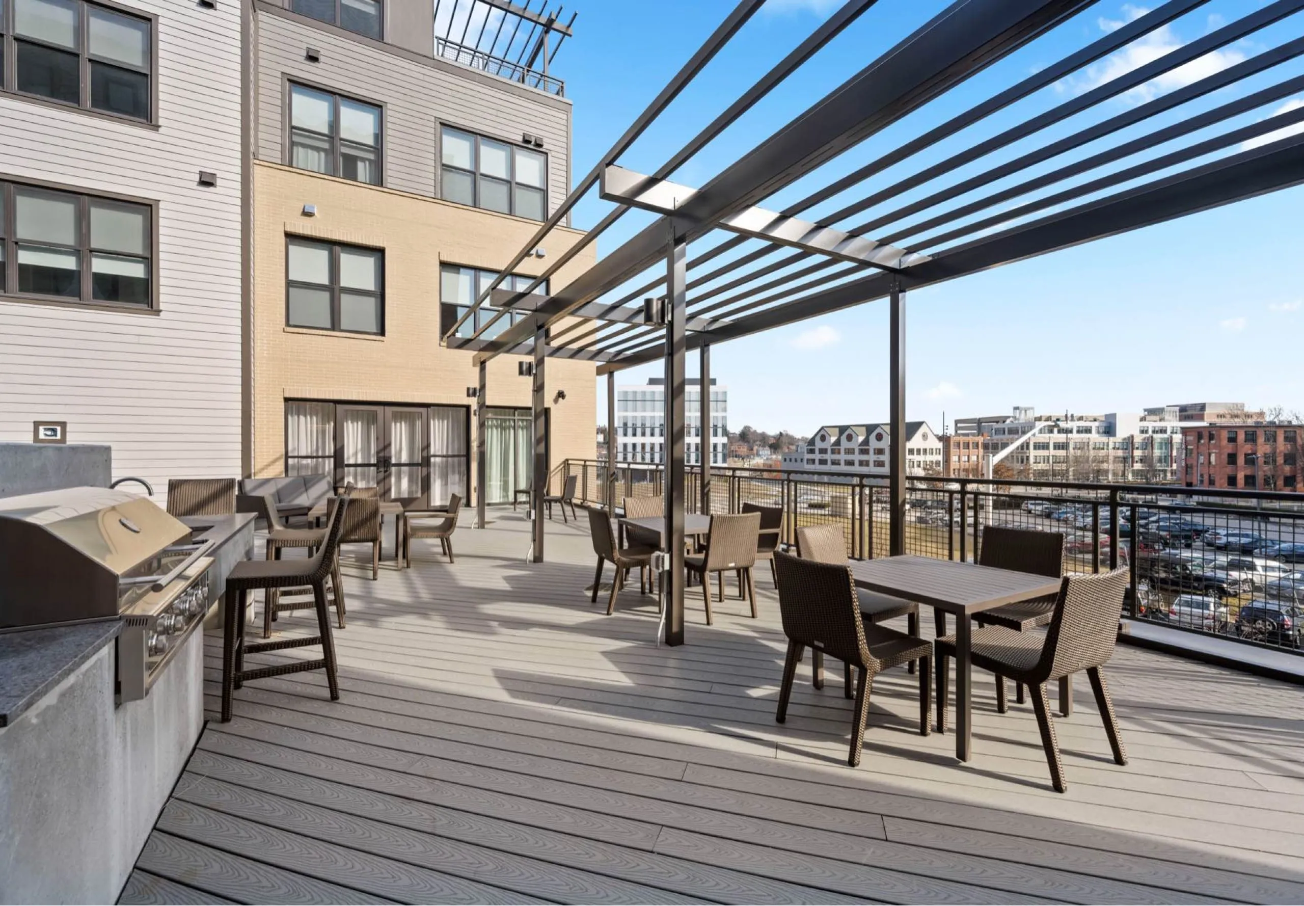 Grill and outdoor seating area in courtyard of Emblem 125 apartment complex