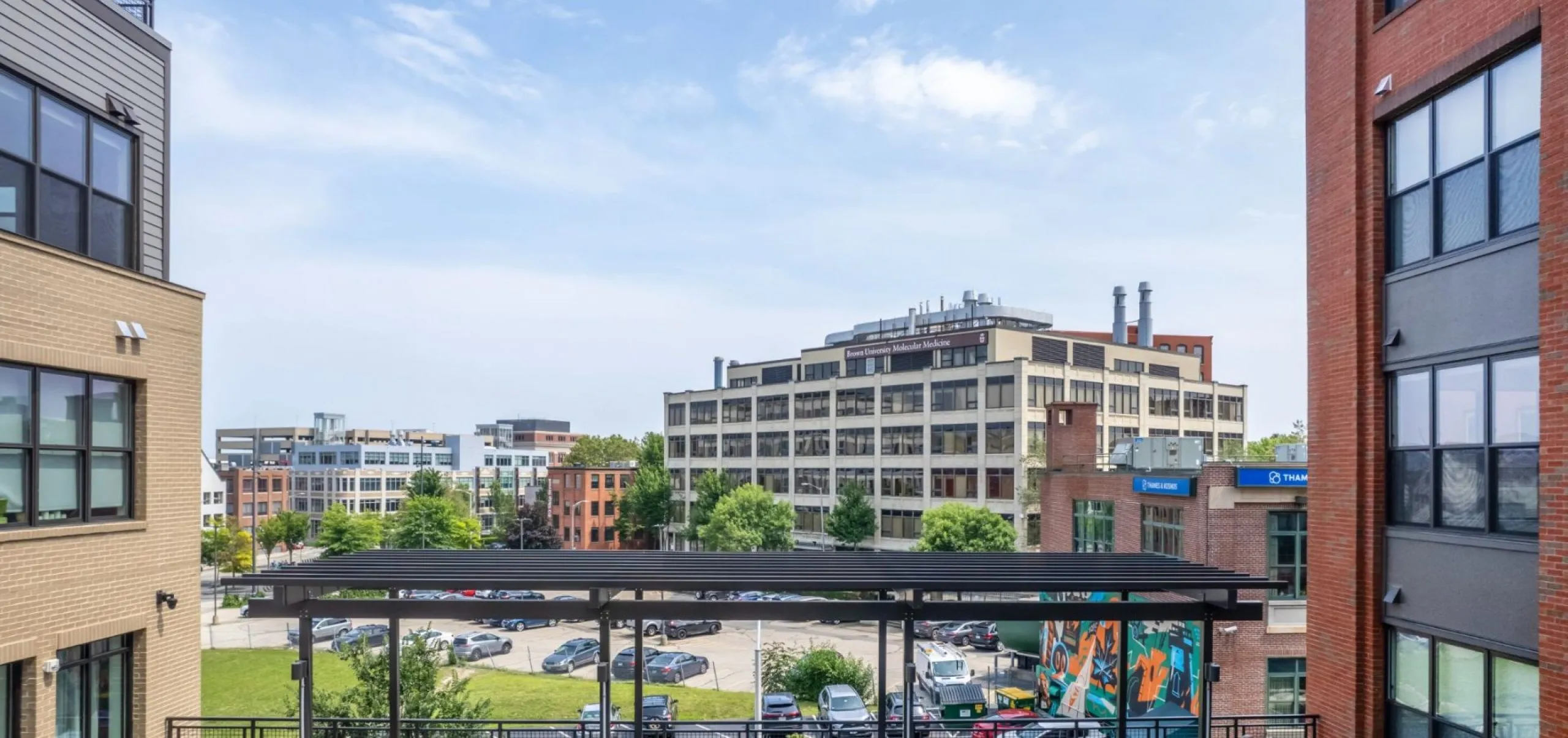 Courtyard with view of skyline in background at Emblem 125 apartment complex