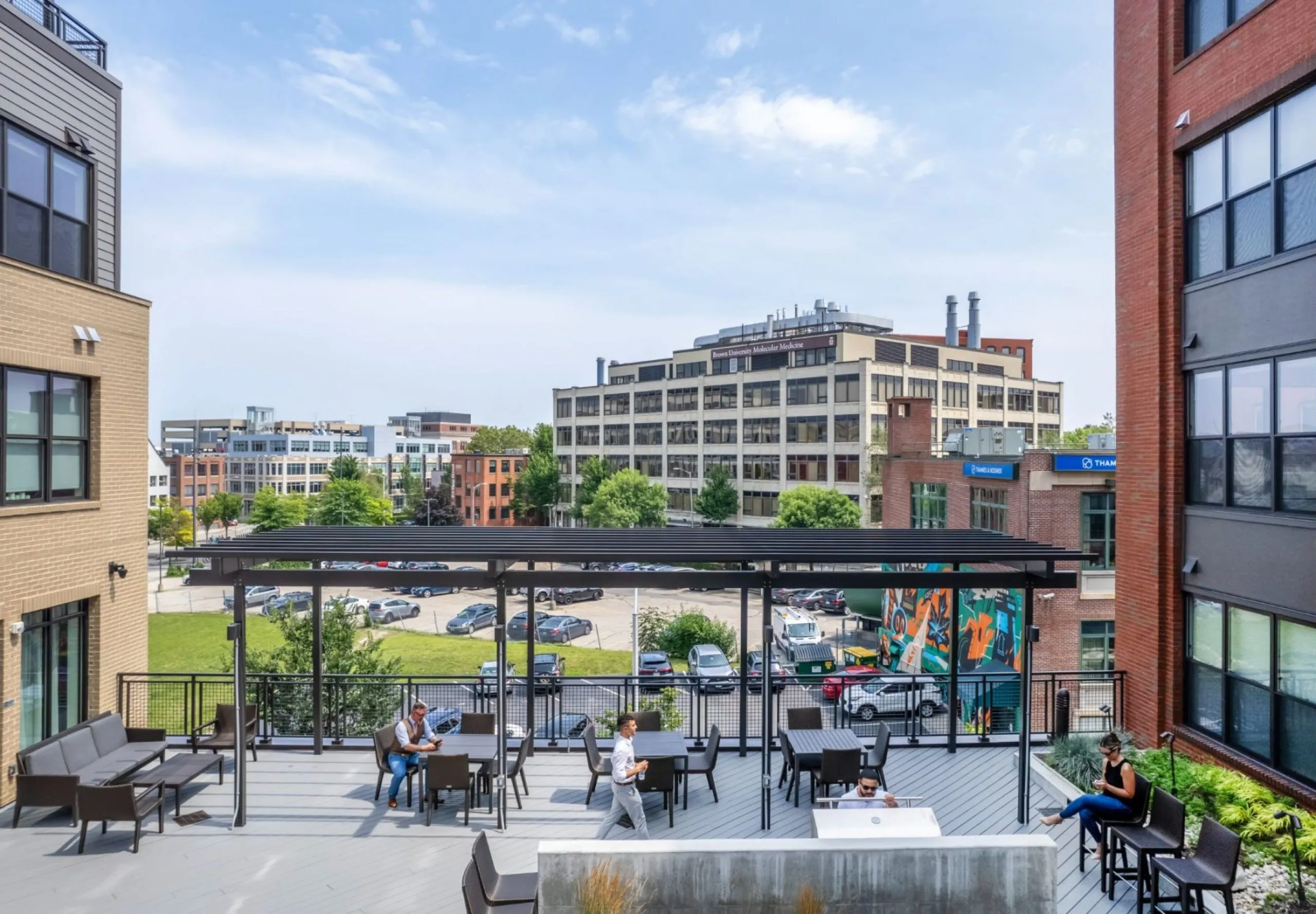 Courtyard with view of skyline in background at Emblem 125 apartment complex