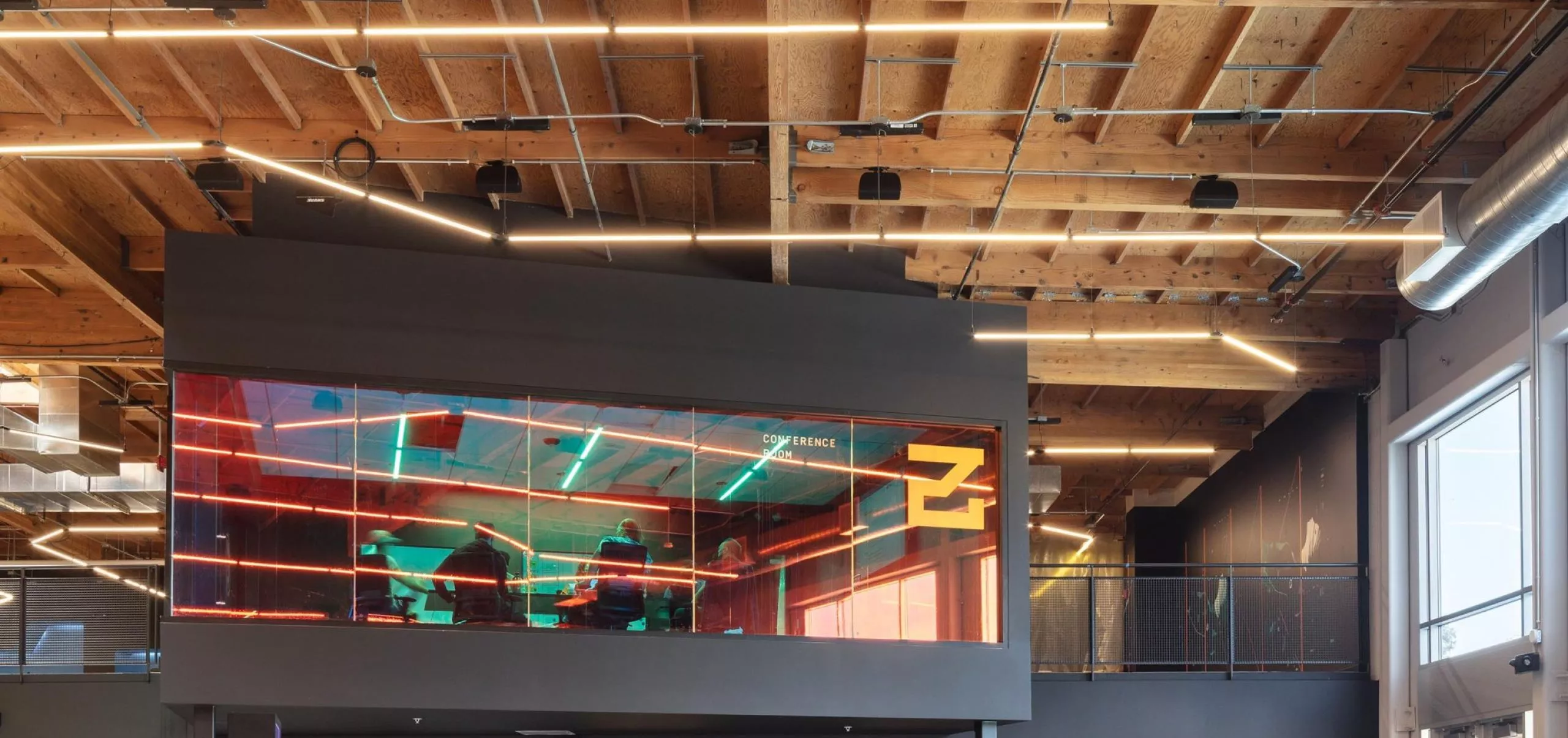 Modern open-concept seating area with meeting room at G4 offices