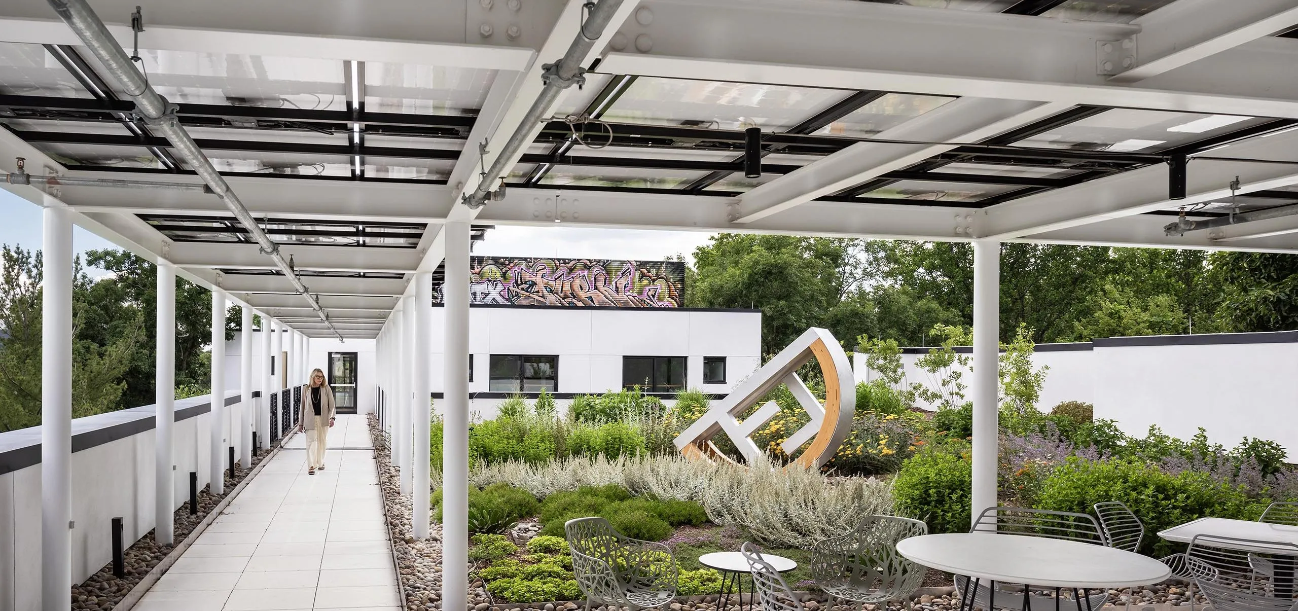 Outdoor garden with statue and covered seating at HMTX Headquarters