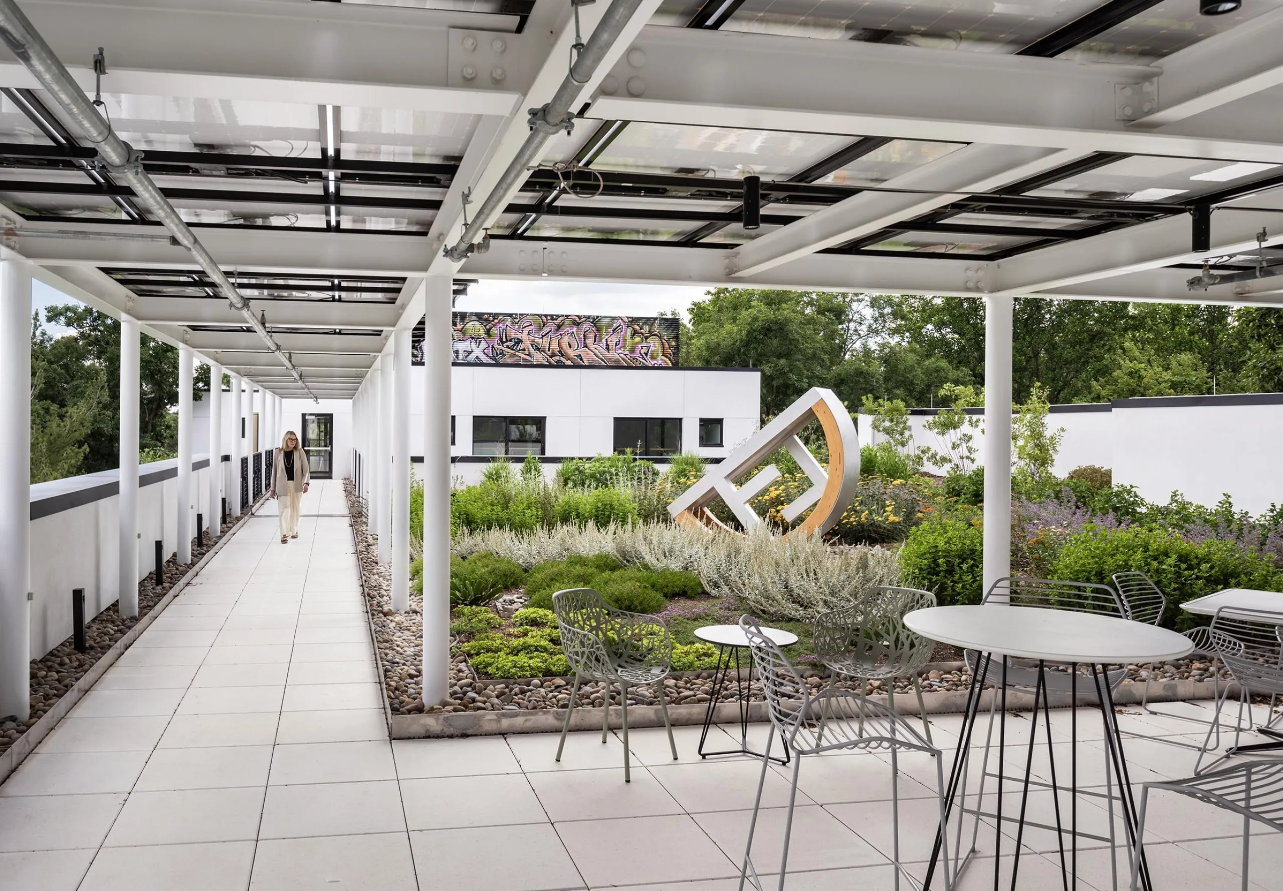 Outdoor garden with statue and covered seating at HMTX Headquarters