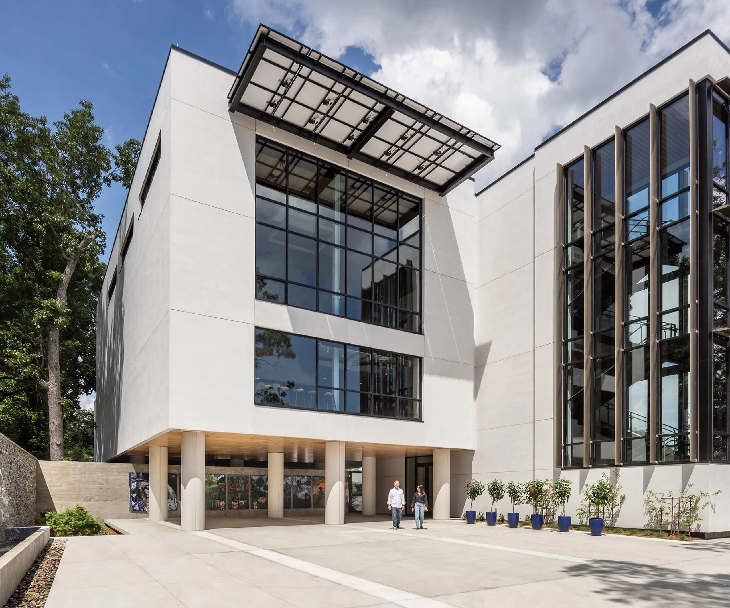 Exterior street view of modern four story office building HMTX Headquarters