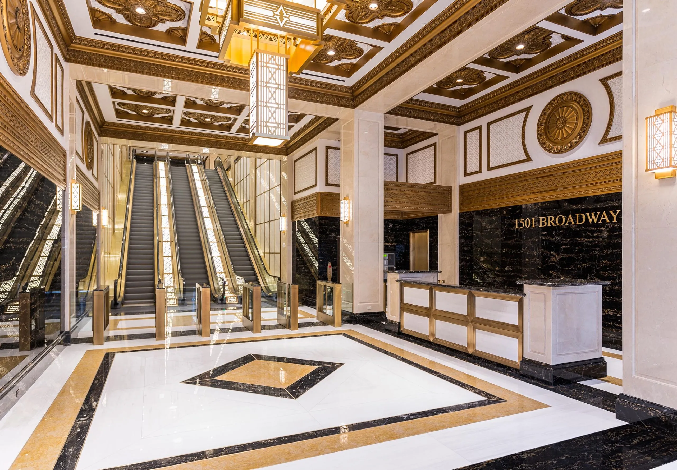 Entryway, front desk and escalators with golden accents at Paramount Building