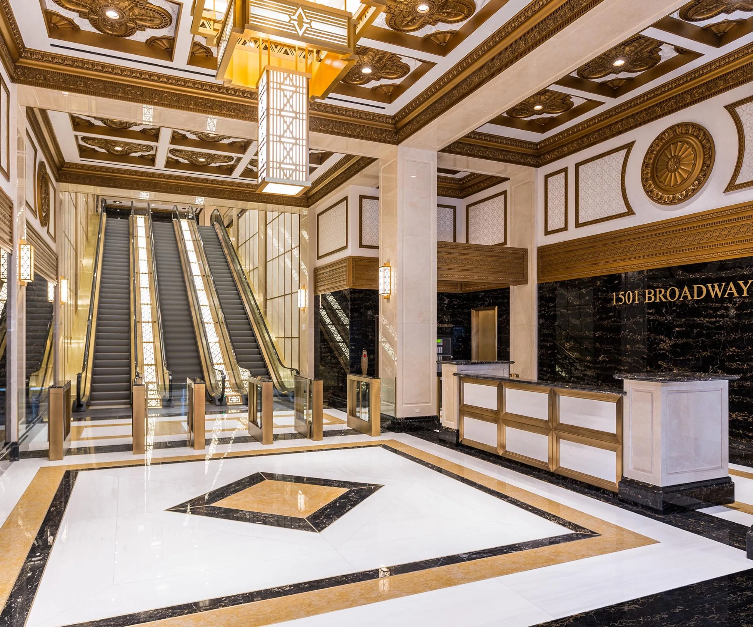 Entryway, front desk and escalators with golden accents at Paramount Building