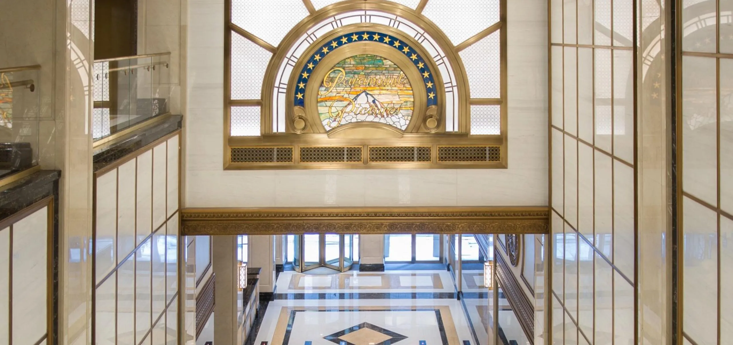 Escalators with golden accents and Paramount logo at Paramount Building