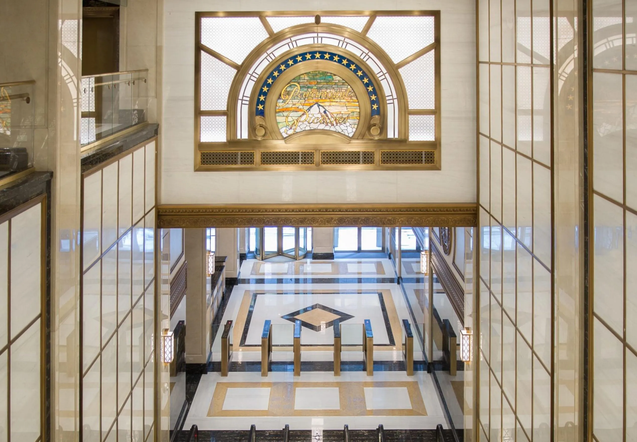 Escalators with golden accents and Paramount logo at Paramount Building