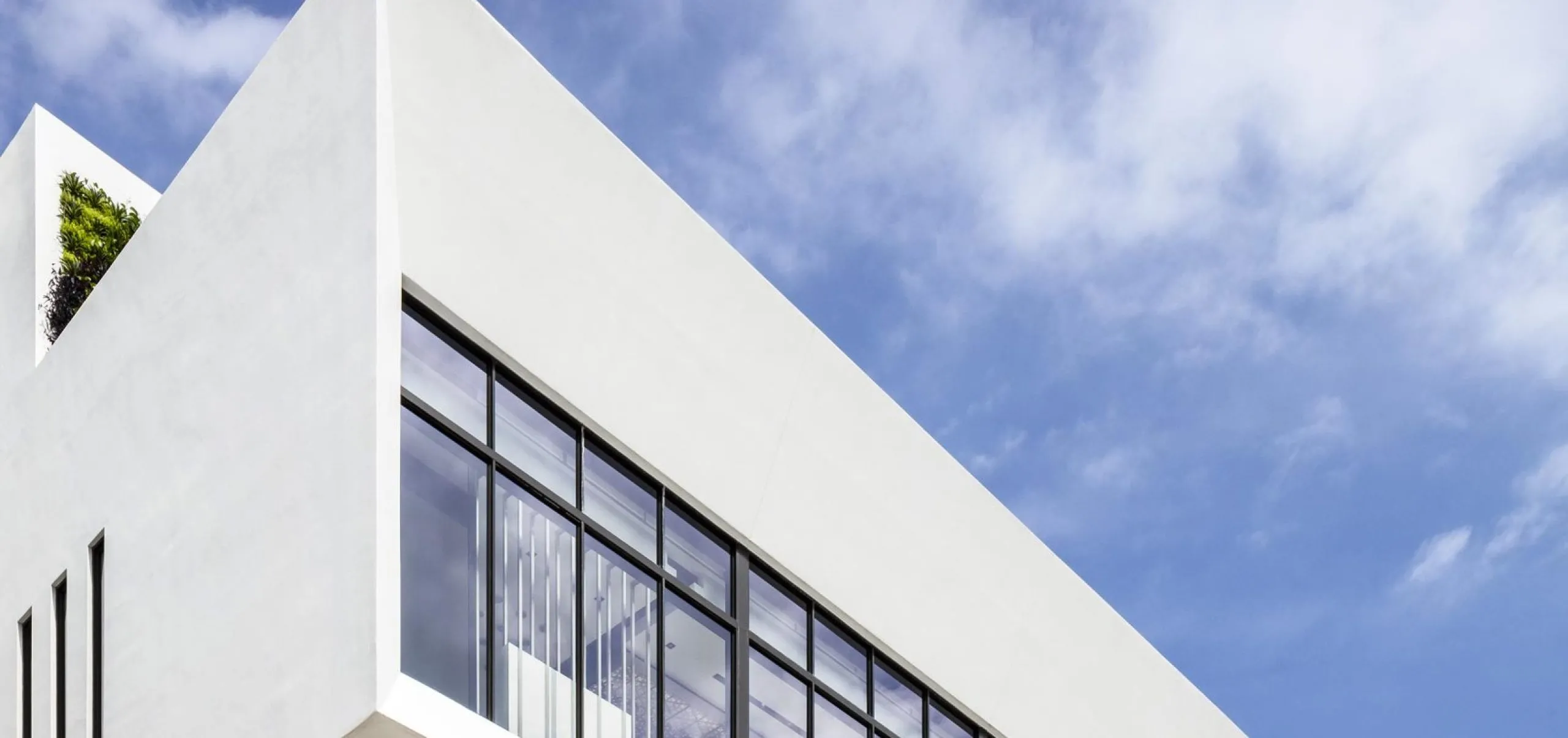 Street view with art visible in the windows at the Power Design Building