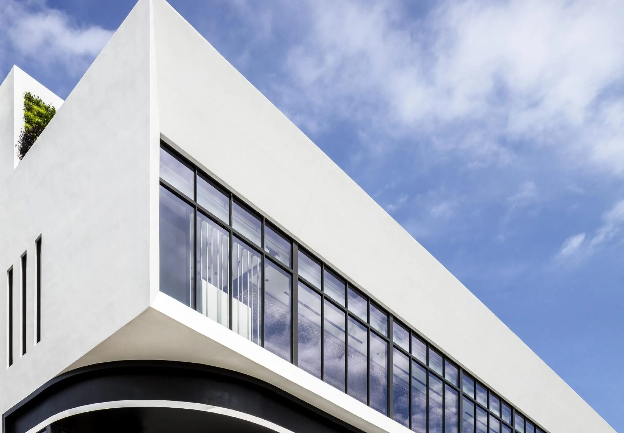 Street view with art visible in the windows at the Power Design Building