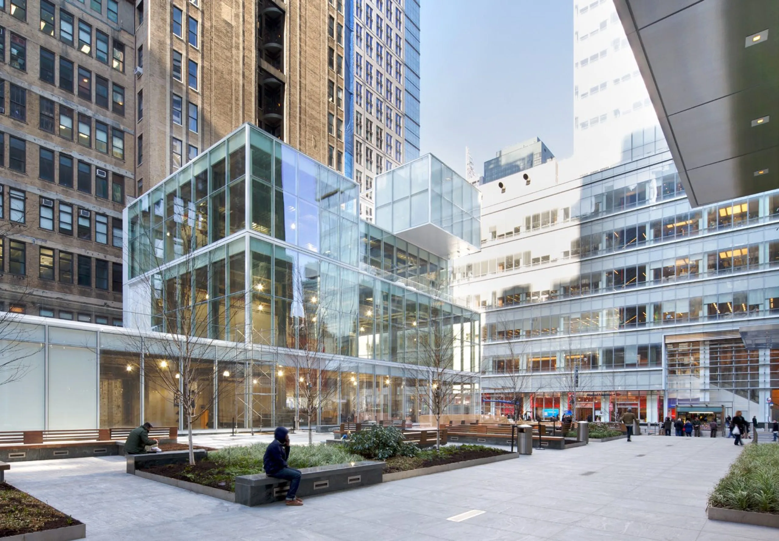 Multistory office building with protruding cubes and exterior seating area