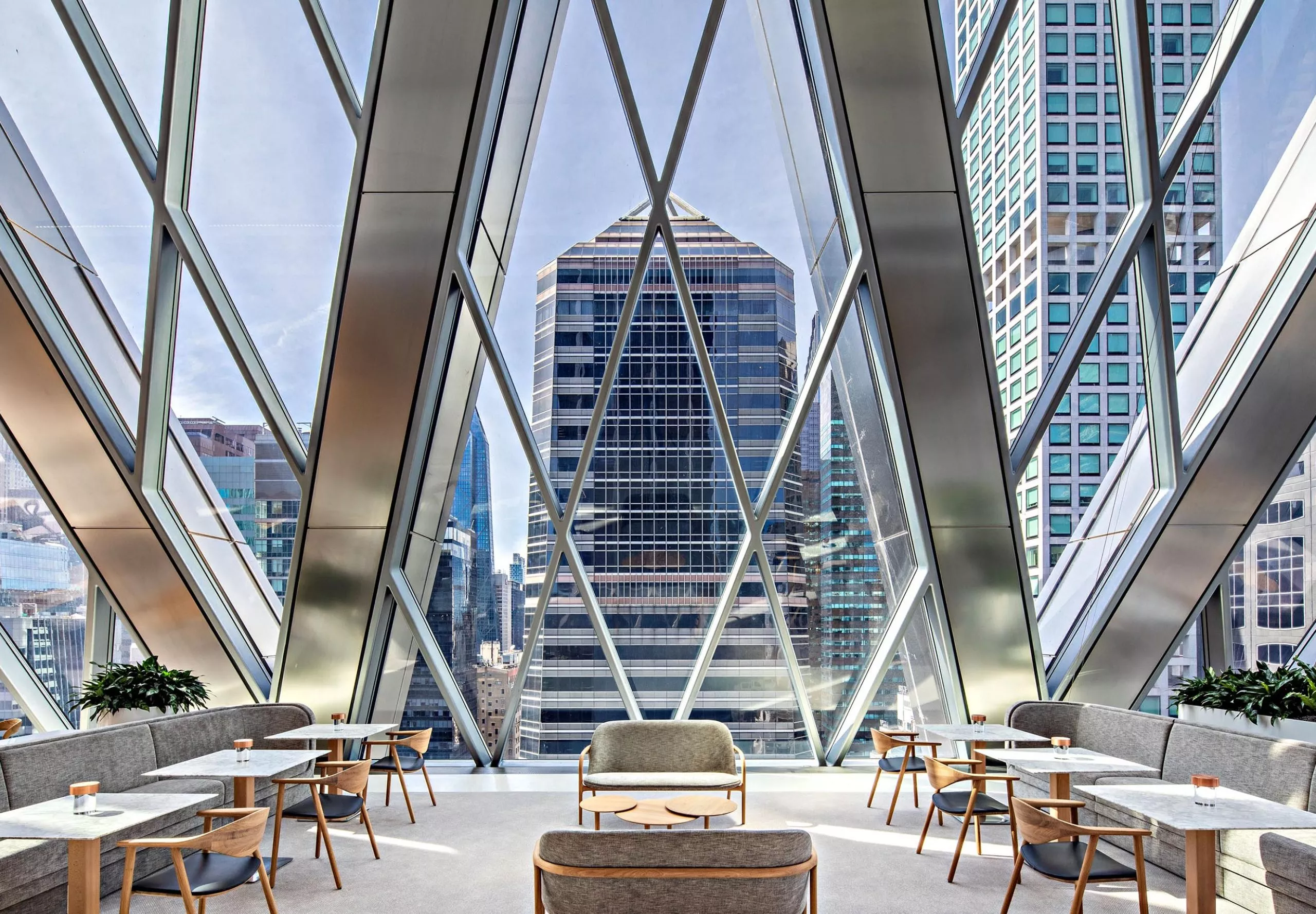 Dining and seating areas with large diamond windows at the Diagrid Club