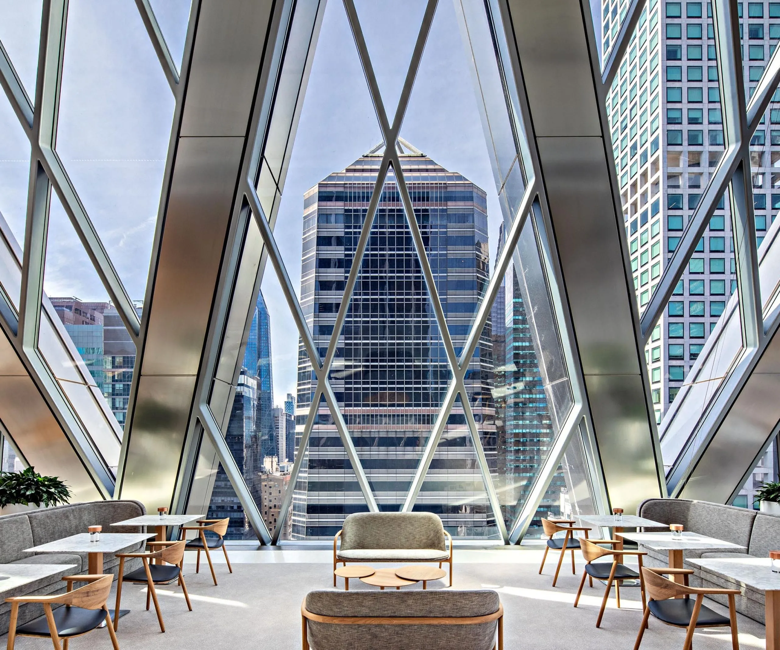 Dining and seating areas with large diamond windows at the Diagrid Club