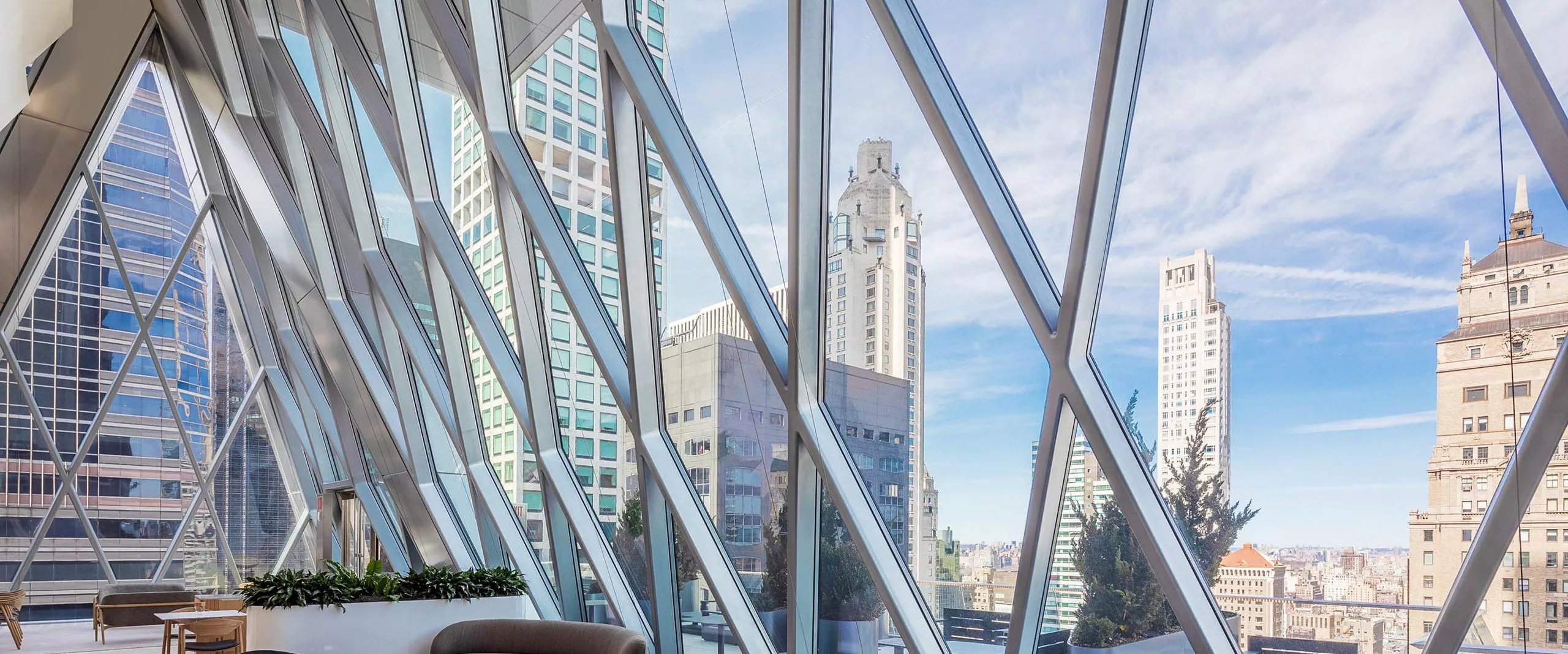 Seating areas with large diamond windows at the Diagrid Club