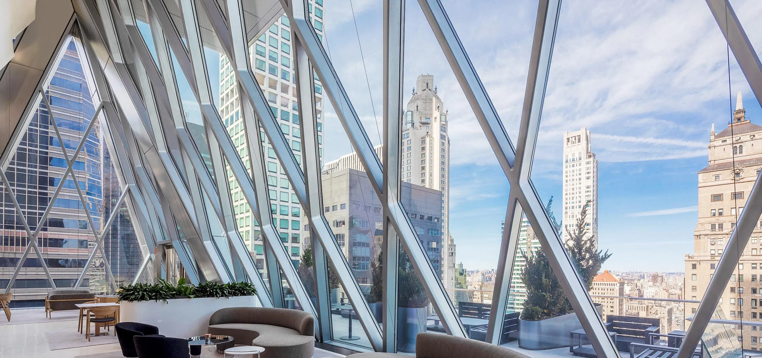 Seating areas with large diamond windows at the Diagrid Club