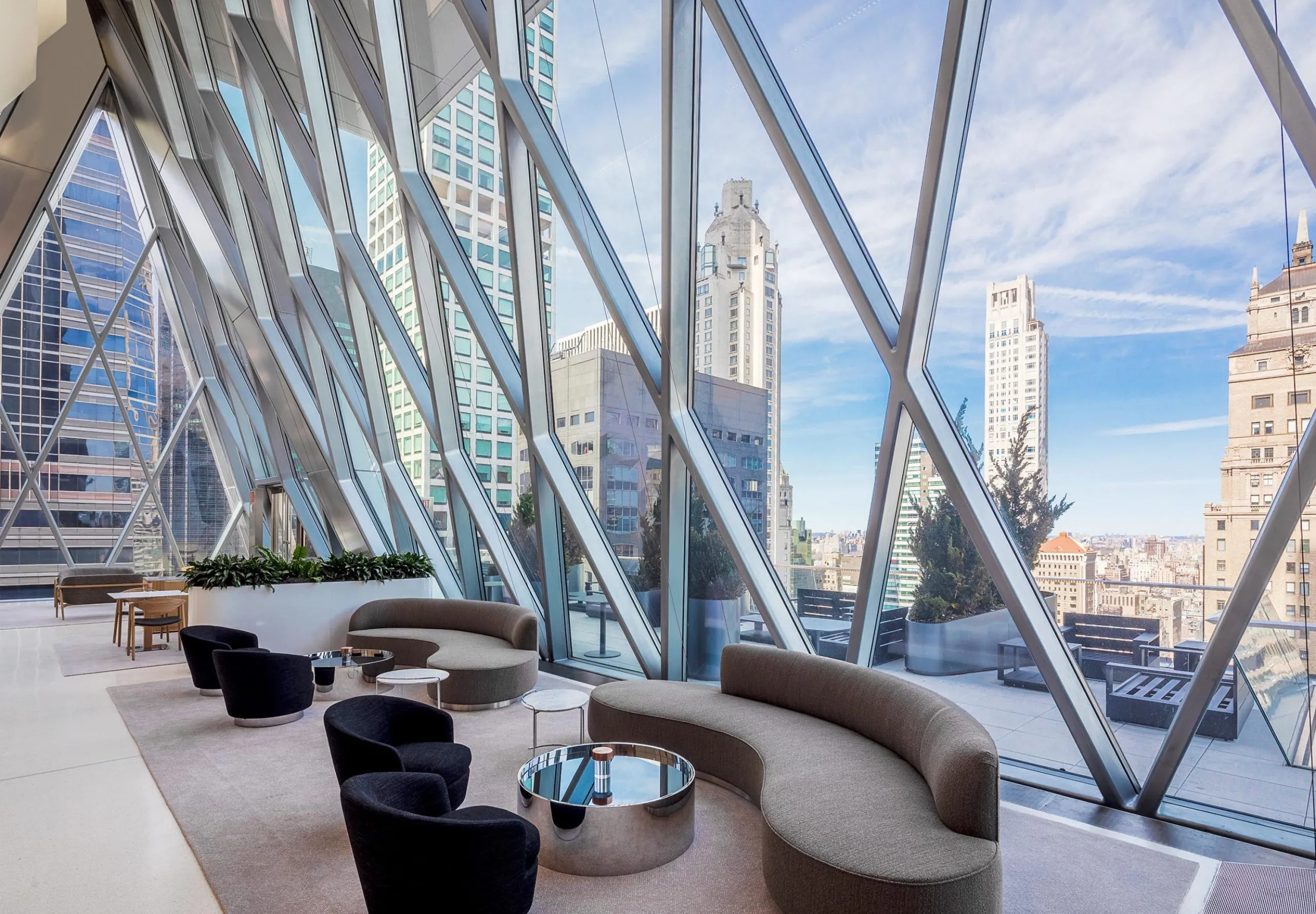 Seating areas with large diamond windows at the Diagrid Club