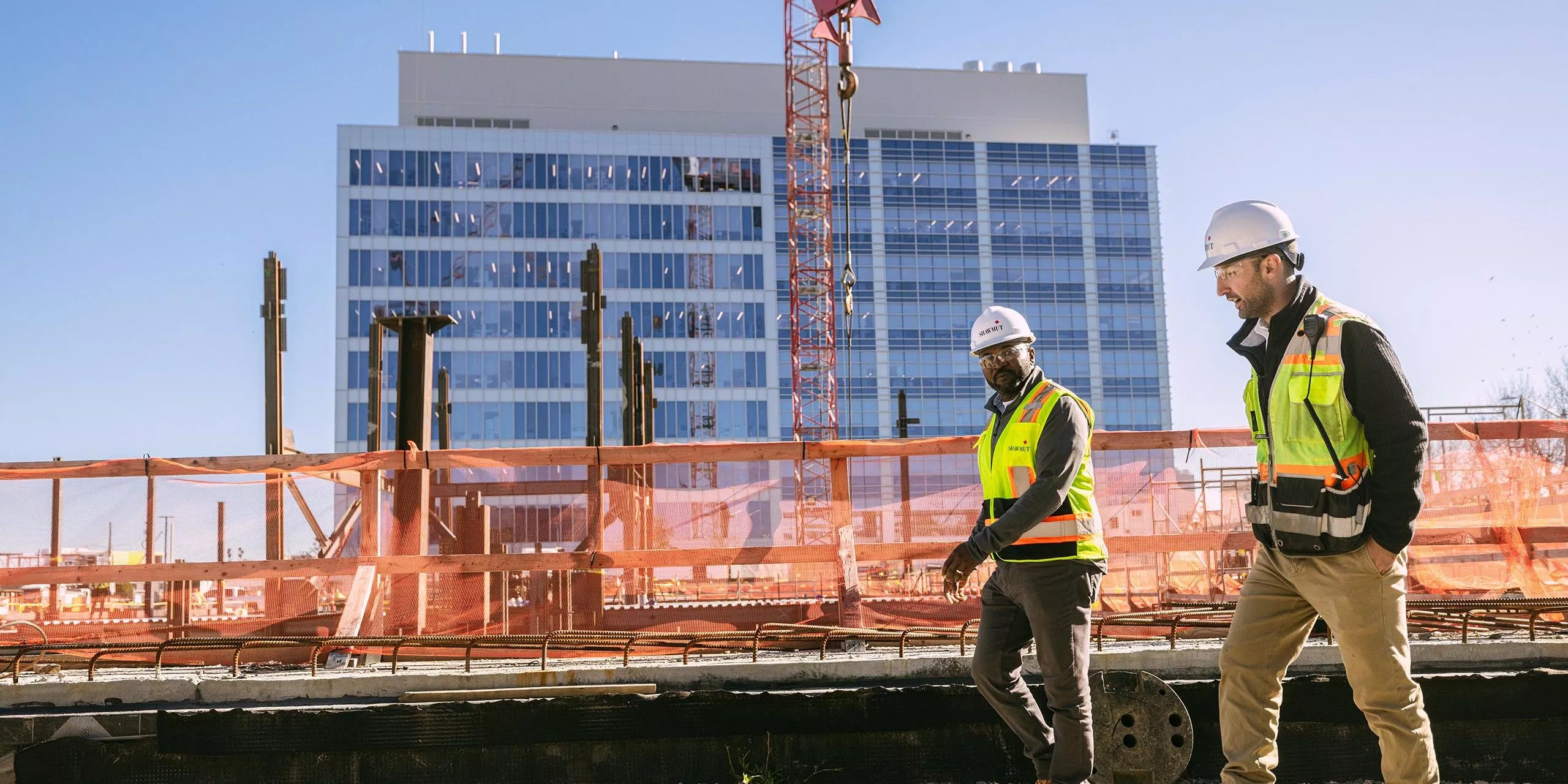 Two men in safety gear on a construction site