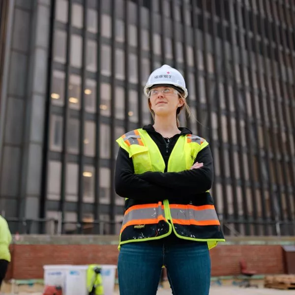 Shawmut employee standing in construction site