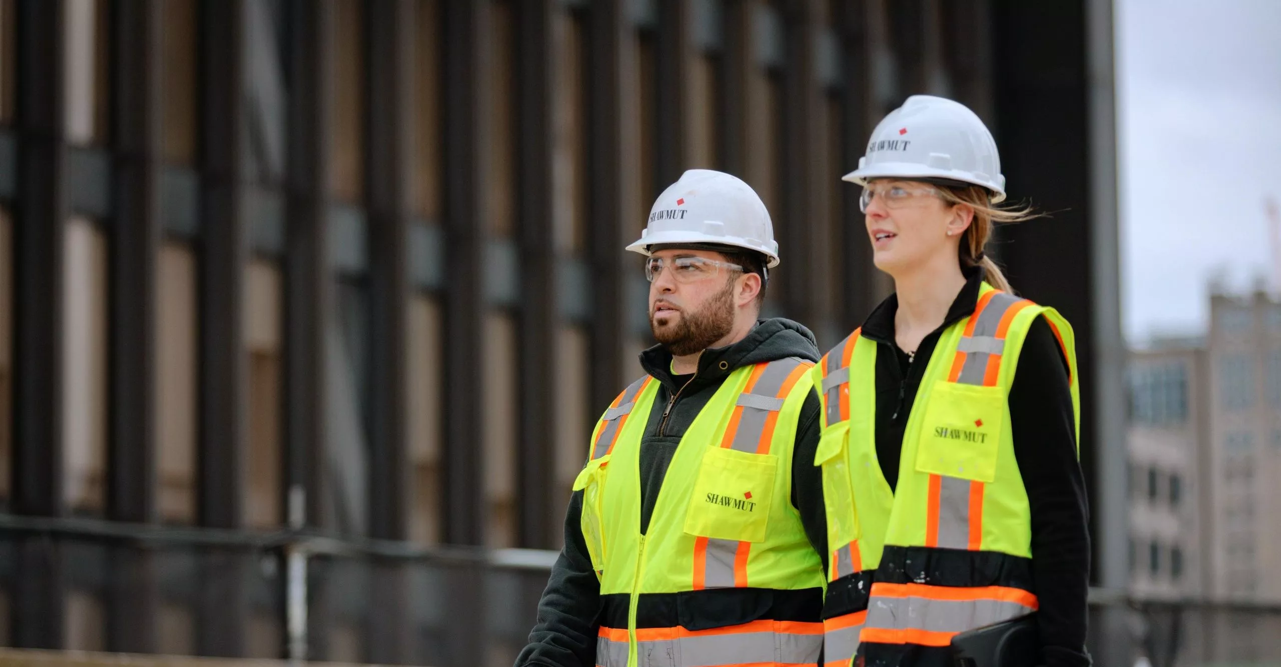 Two people in safety gear on construction site