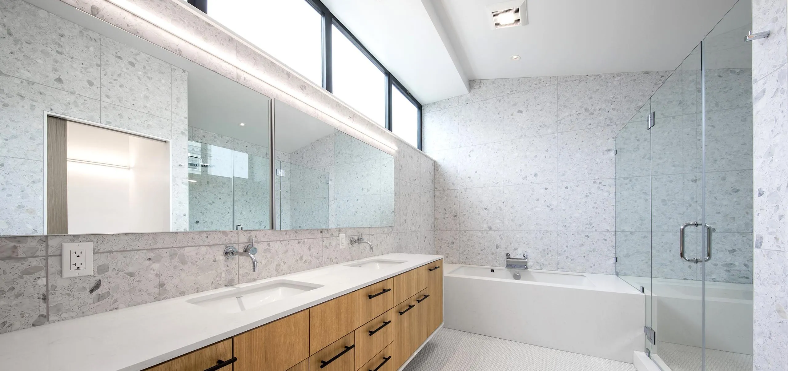 Interior view of a bathroom with bathtub, shower, and sink