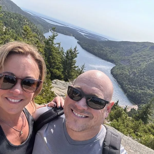 Ron Somineau with a woman with the mountains in the background