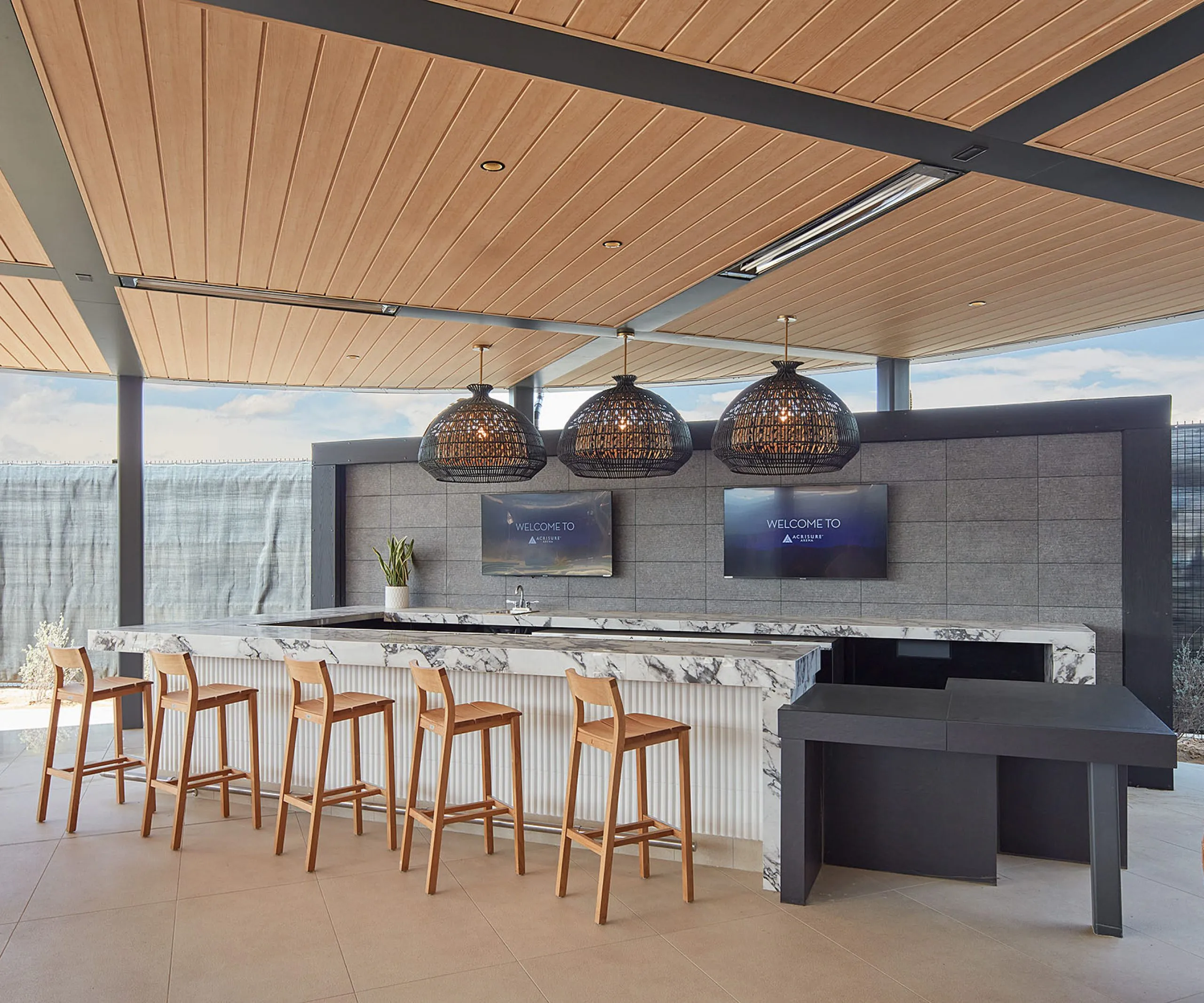 Covered bar and seating area at Acrisure Arena