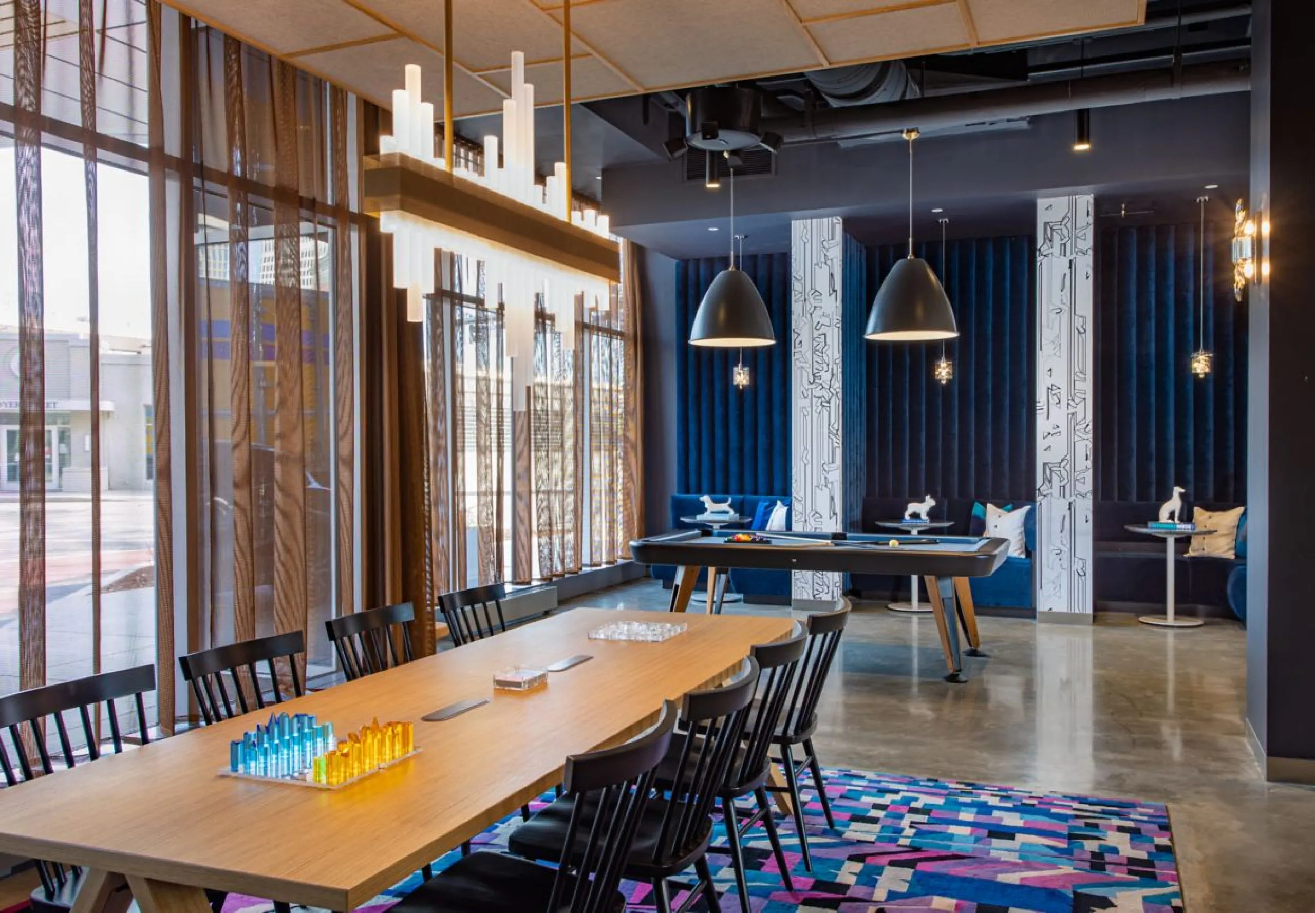 Common space with a pool table and dinning table at the Aloft Providence Downtown