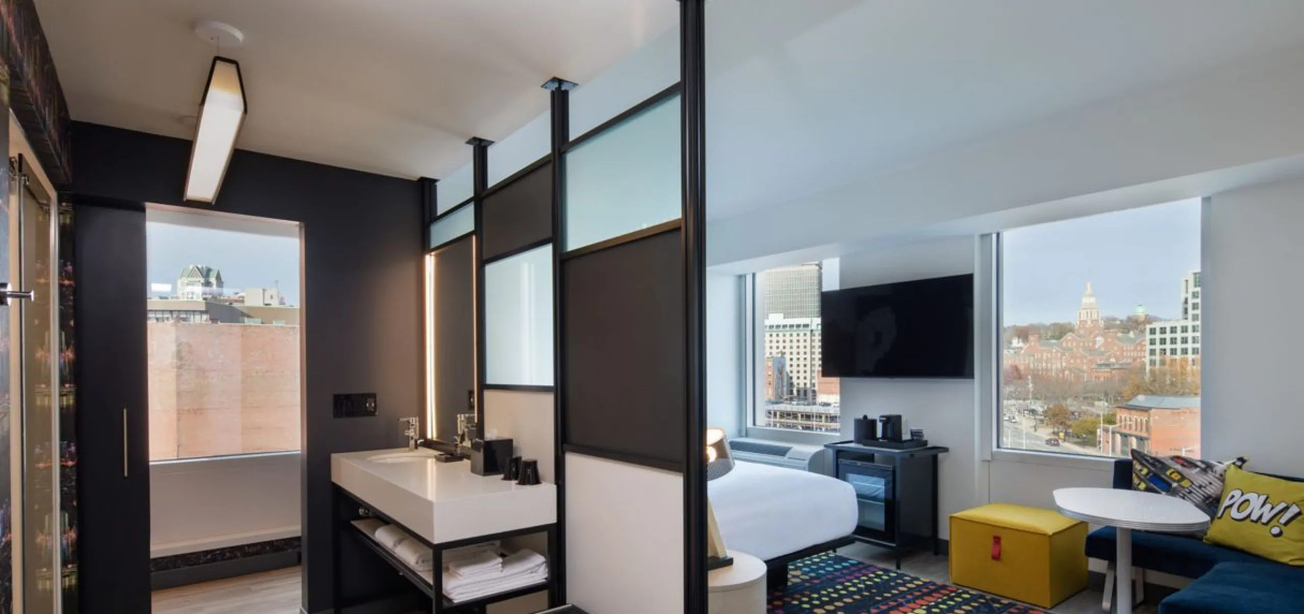 Interior view of a studio bathroom and bedroom at the Aloft Providence Downtown