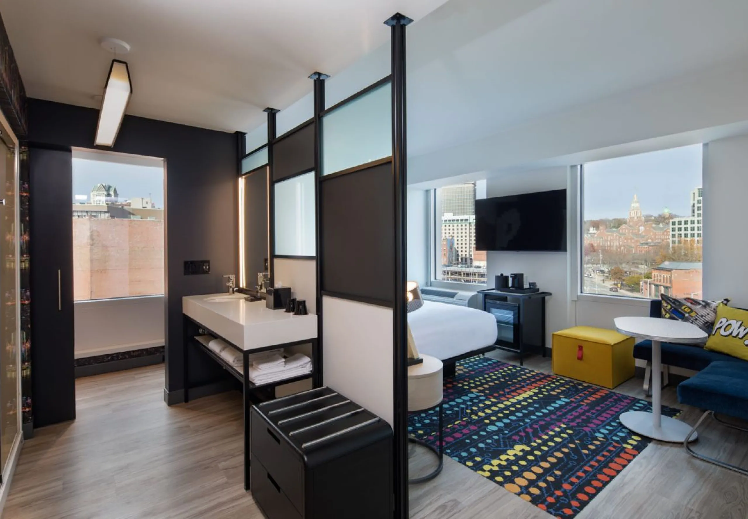 Interior view of a studio bathroom and bedroom at the Aloft Providence Downtown