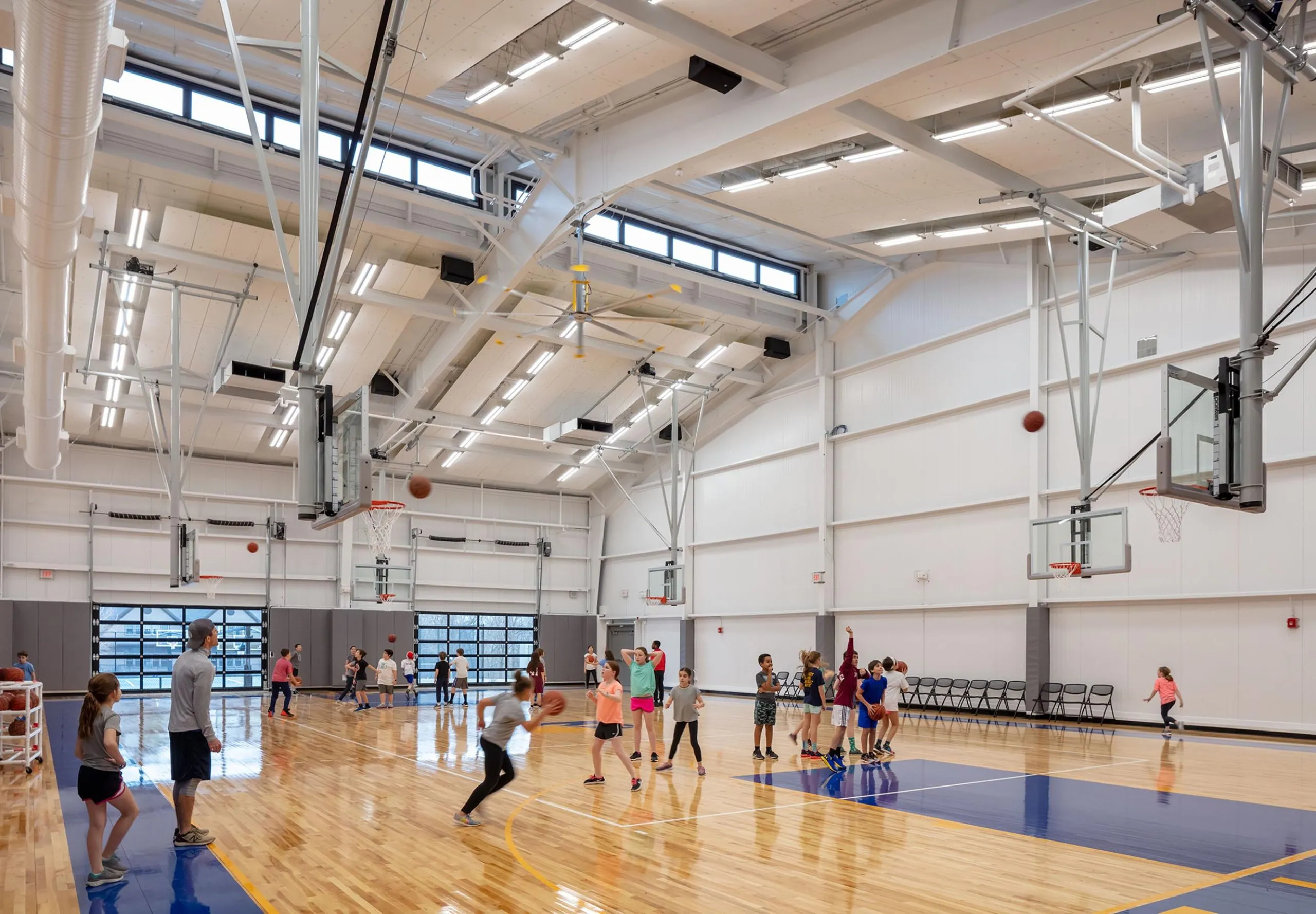 Children playing basketball in gym at Belmont Day School