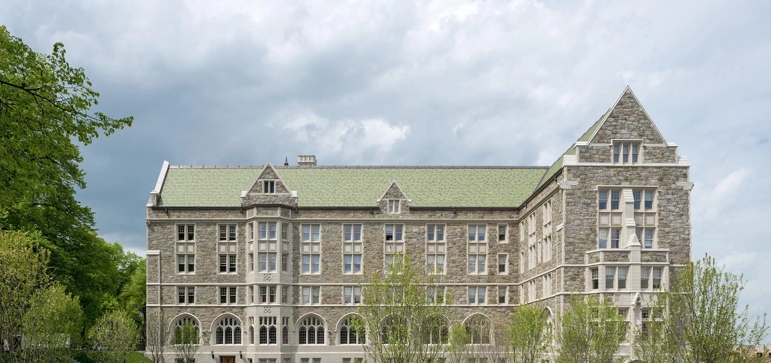 a building with a lawn and benches