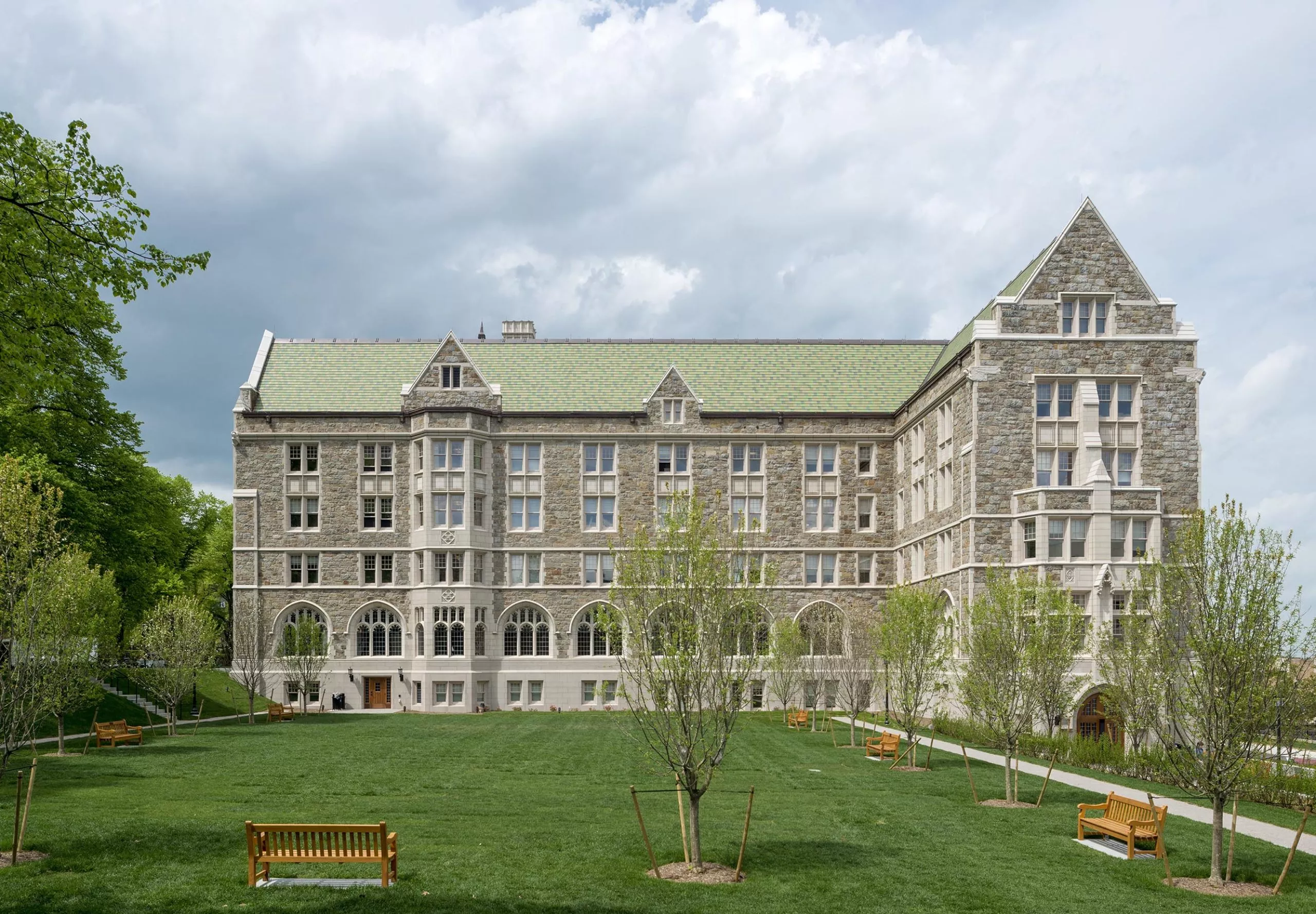 a building with a lawn and benches