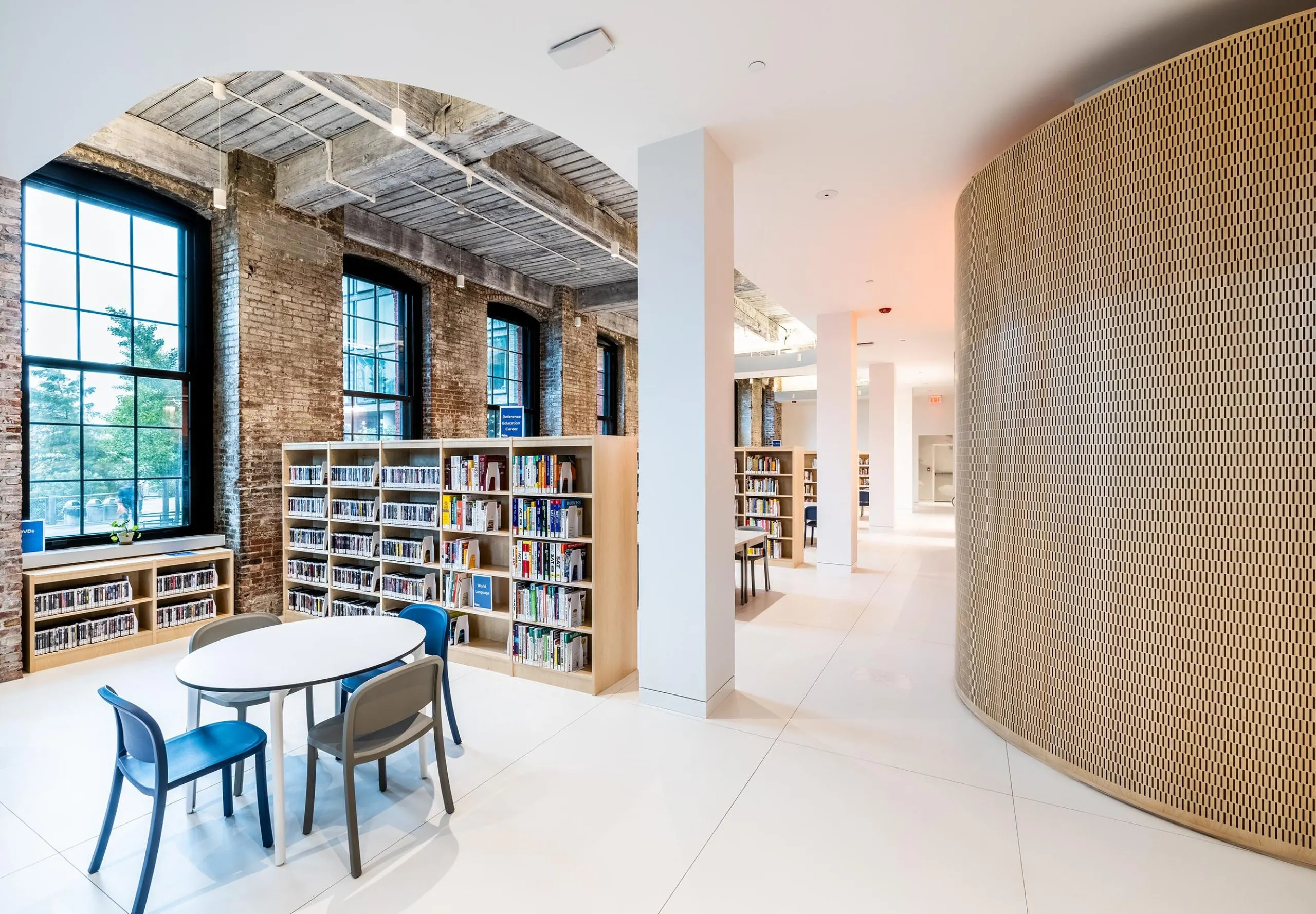 Modern and brick interior of Adams Street Library with bookshelves and children's seating