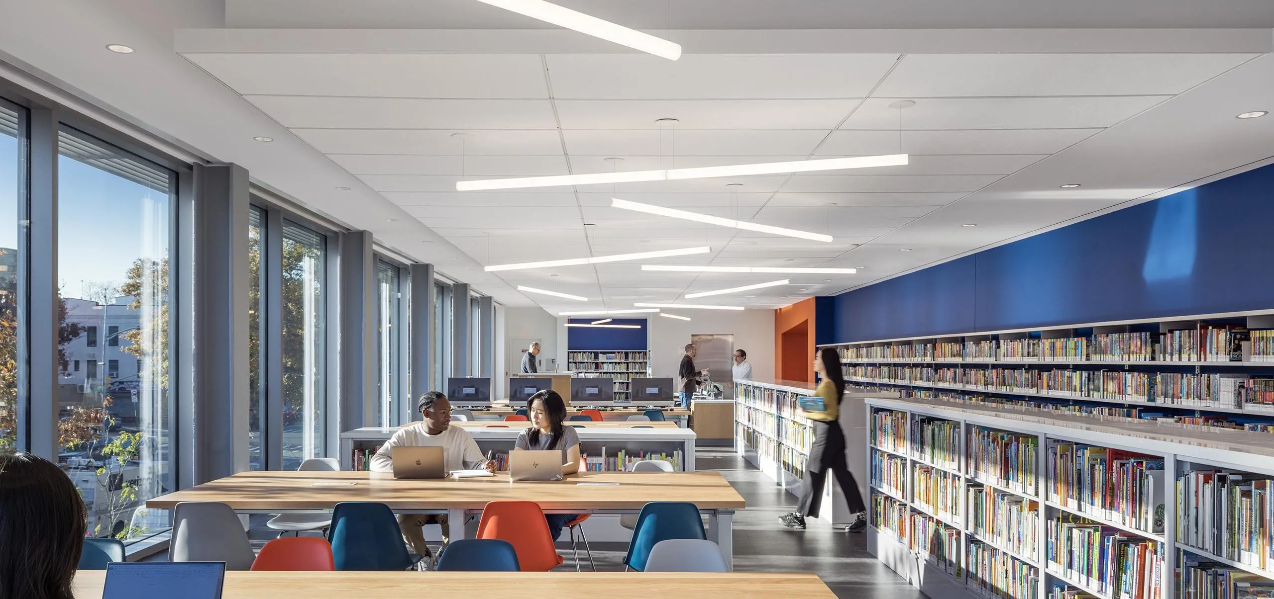 Tables and bookselves at Sunset Park Library