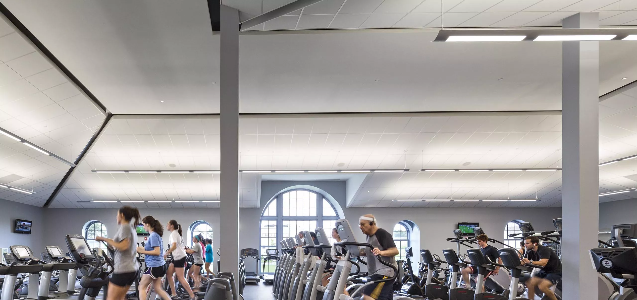 People on exercise equipment inside Nelson Fitness & Coleman Aquatics Center